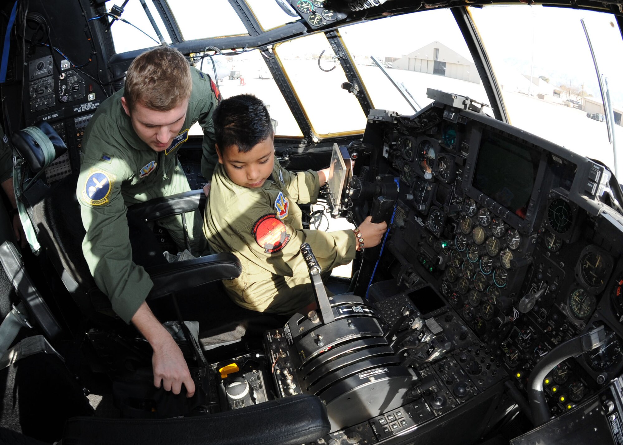 1st Lt. John Graham, 79th Rescue Squadron, explains to 7-year-old Marcus Lucero some of the duties and responsibilites of an HC-130 pilot during his Pilot for a Day tour here Feb. 19. As part of the Pilot for a Day program, Marcus and his family were provided with a tour of the base, which included the chance to see an A-10 Thunderbolt, an HC-130 Hercules and an HH-60 Pavehawk. This program affords children with disabilities or serious illnesses with a day devoted to them and their interest in aviation. (U.S. Air Force photo/ Airman Jerilyn Quintanilla)