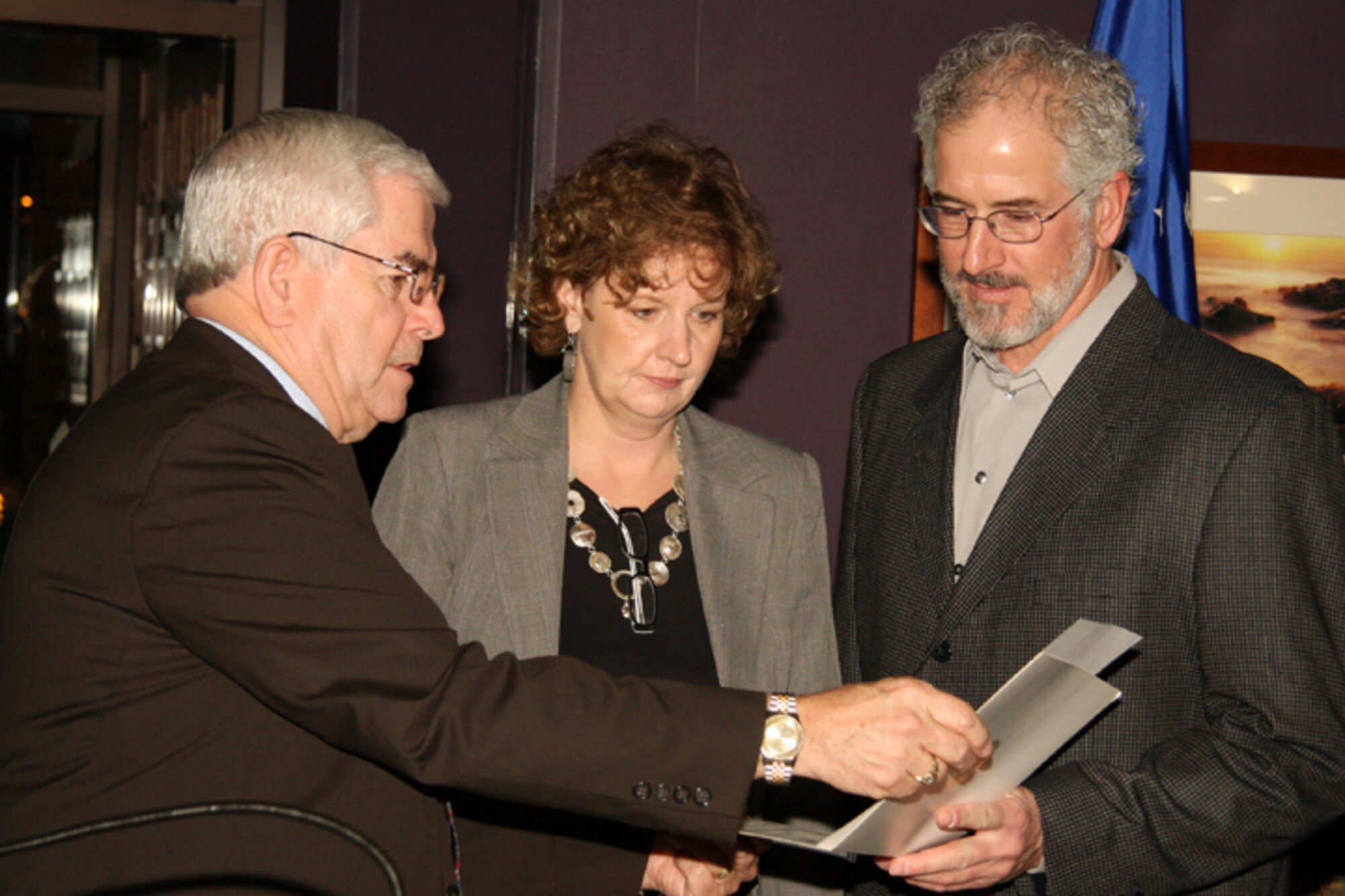 GRISSOM AIR RESERVE BASE, Ind., -- Mr. Hal Job, Grissom Community Council vice president (left), and the council's newest two members, Robert and Mary Hettmansperger, review a special membership certificate.  The Hettmanspergers were presented with the certificate during the 2010 Annual Award Banquet at Grissom ARB.  (U.S. Air Force photo/Tech. Sgt. Mark. R. W. Orders-Woempner)
