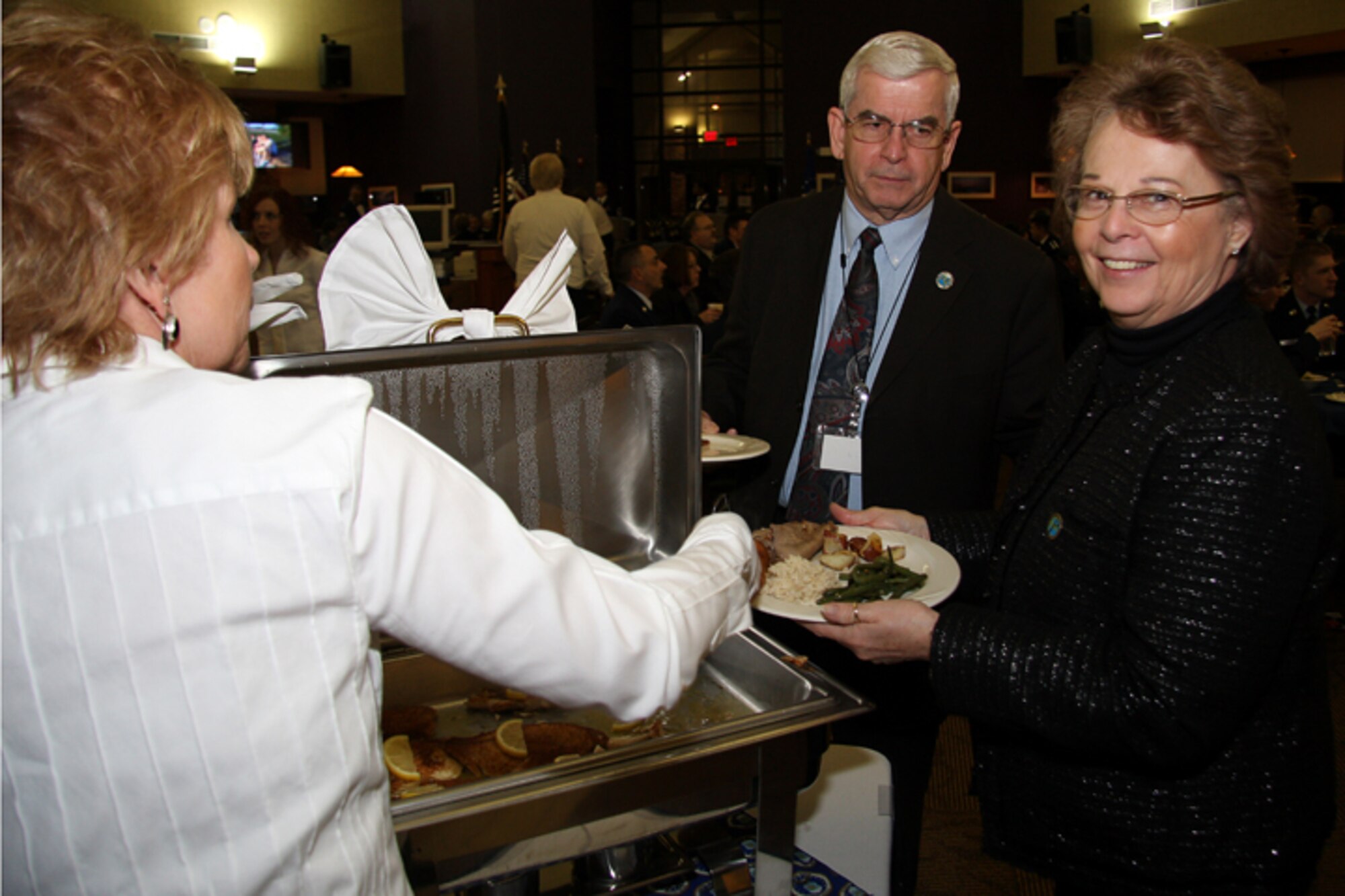 GRISSOM AIR RESERVE BASE, Ind., -- Mr. and Mrs. Hal Job of the Grissom Community Council go through the buffet line.  The Jobs were part of a large contingent of council members and local civic leaders who were in attendance at the 2010 Annual Awards Banquet.  Mr. Job served as the GCC president in 2008 and 2009 and will serve as vice president in 2010. (U.S. Air Force photo/Tech. Sgt. Mark Orders-Woepmner)