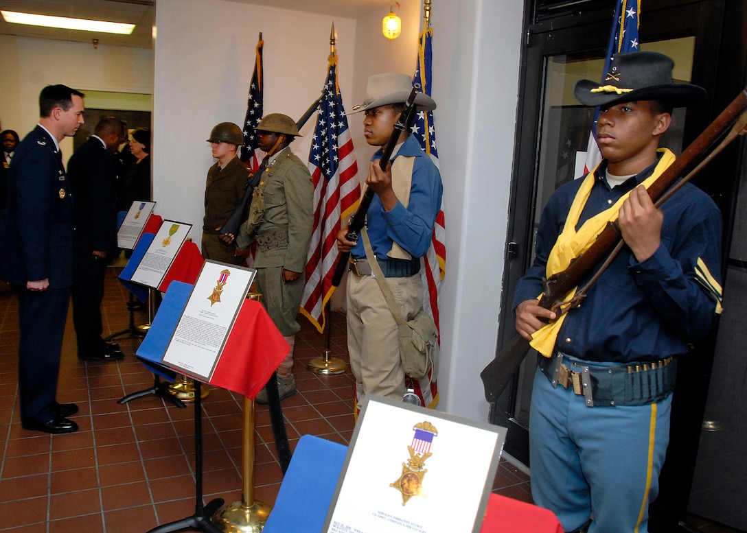 Airmen in Training wear the uniforms of Medal of Honor recipients from the Civil War to the Vietnam War time frame as live models during the Living Legends Banquet Museum at the Community Center Feb. 19.  (U.S. Air Force photo/Mike Litteken)
