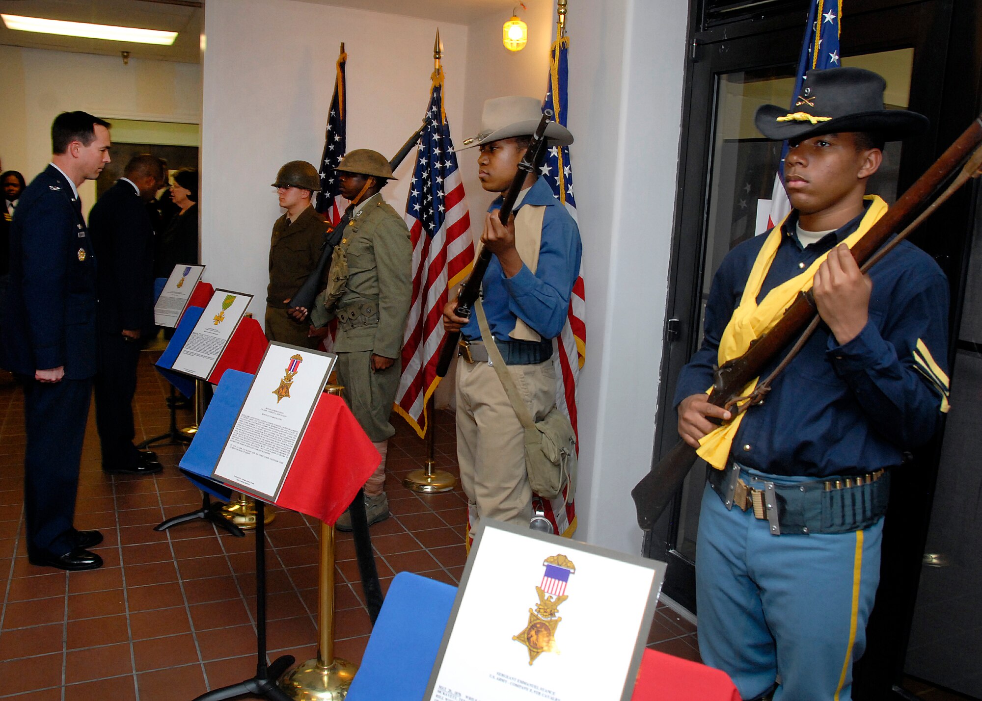 Airmen in Training wear the uniforms of Medal of Honor recipients from the Civil War to the Vietnam War time frame as live models during the Living Legends Banquet Museum at the Community Center Feb. 19.  (U.S. Air Force photo/Mike Litteken)