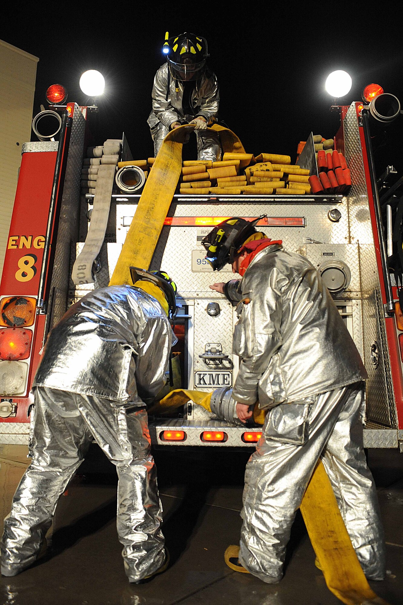 ELLSWORTH AIR FORCE BASE, S.D.-- 28th Civil Engineer Squadron firefighters roll a hose into a fire truck during a night structural fire training exercise, Feb. 17. The 28 CES fire department practices various training scenarios to maintain readiness qualifications. (US Air Force photo/Airman 1st Class Corey Hook)