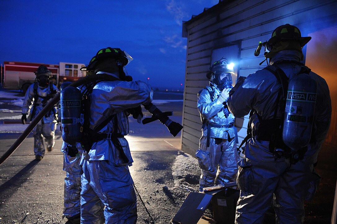 ELLSWORTH AIR FORCE BASE, S.D.-- 28th Civil Engineer Squadron firefighters conduct a night structural fire training exercise, Feb. 17. The 28 CES fire department practices various training scenarios to maintain readiness qualifications. (US Air Force photo/Airman 1st Class Corey Hook)