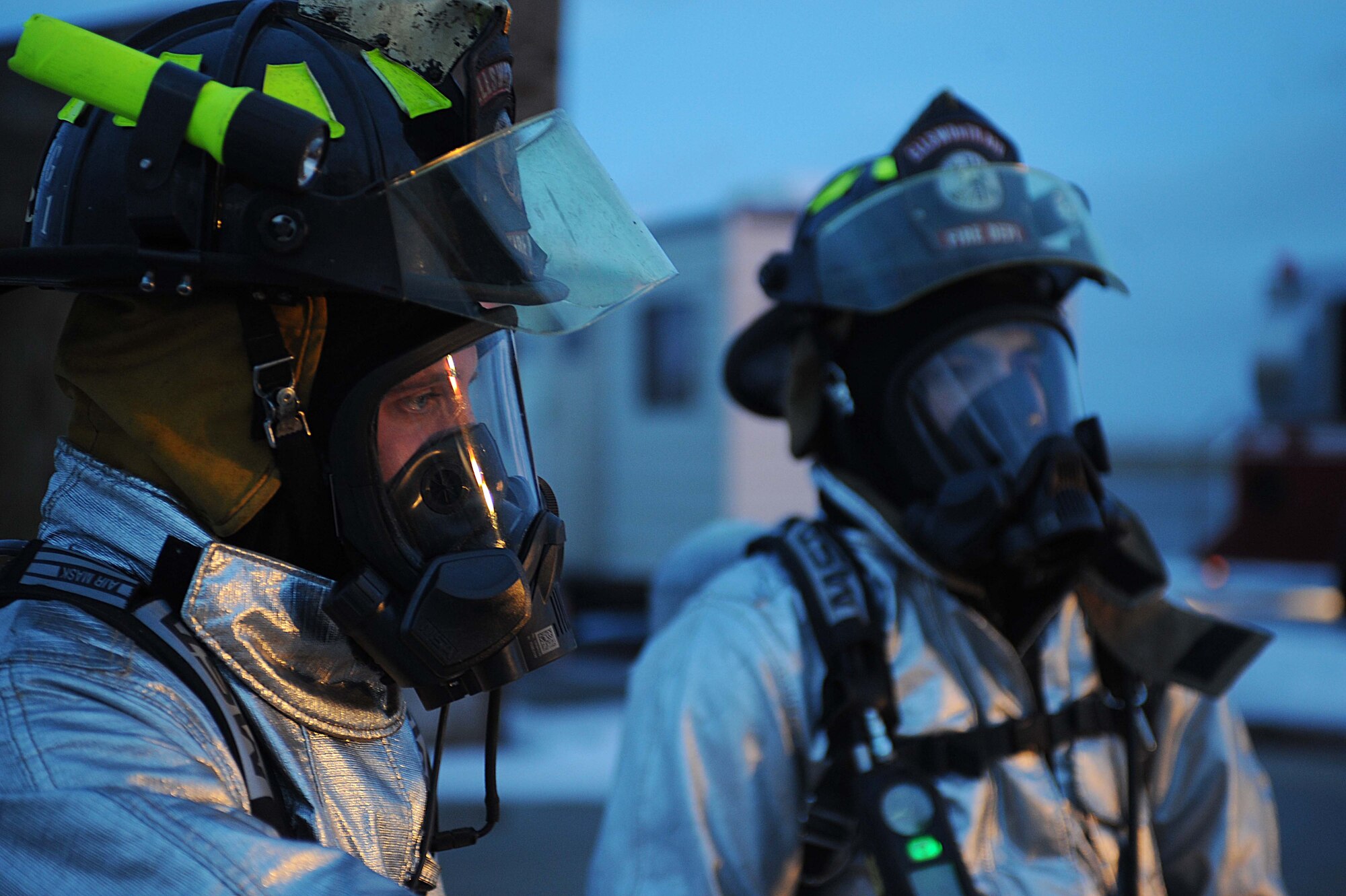 ELLSWORTH AIR FORCE BASE S.D.-- (Left) Senior Airmen Jared Manning and John Vasquez, 28th Civil Engineer Squadron firefighters, stand ready to ignite a fire for a night structural fire training exercise, Feb. 17. The 28 CES fire department conducts various training scenarios to maintain readiness qualifications. (U.S. Air Force photo/Airman 1st Class Corey Hook)