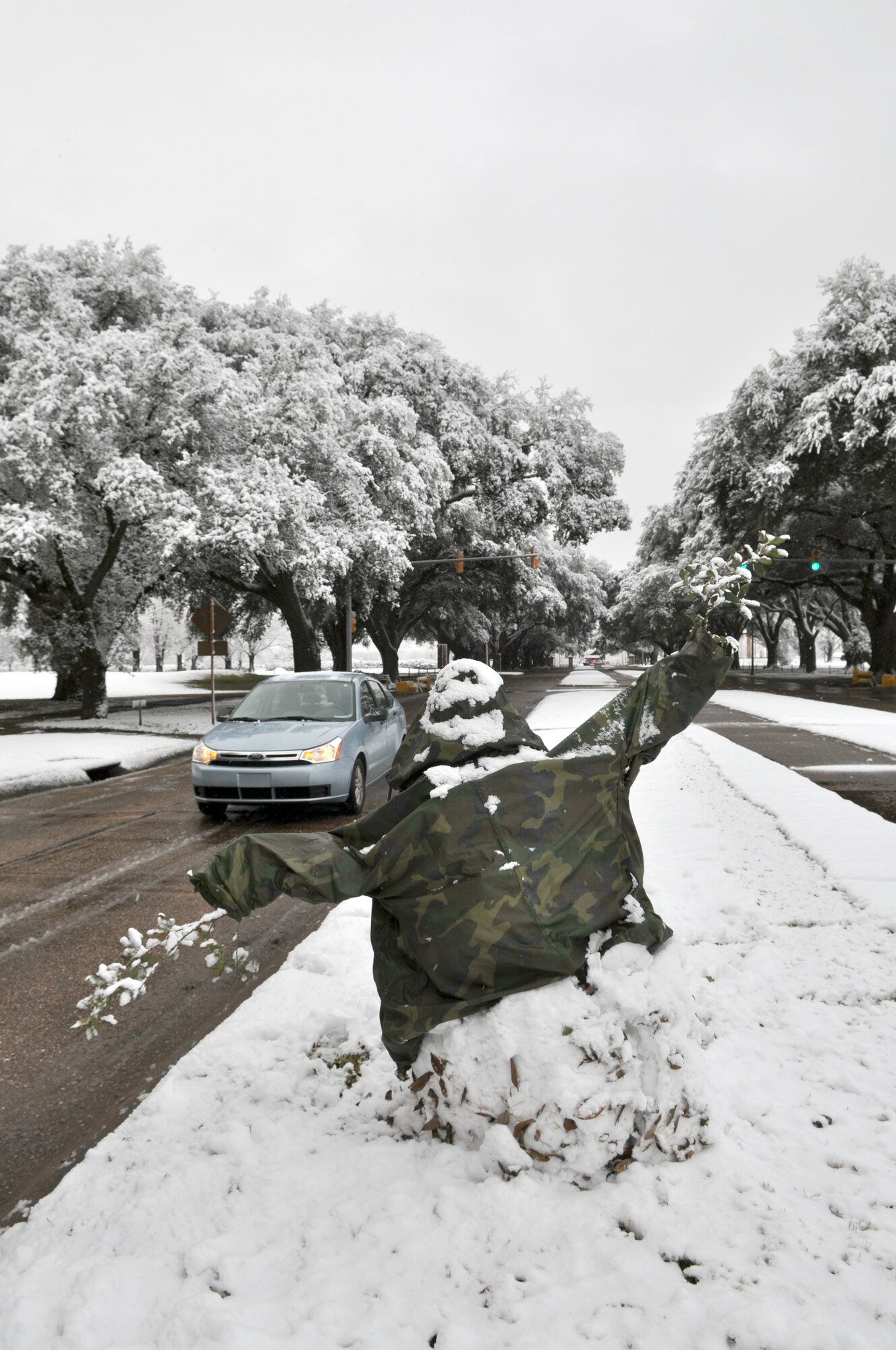 An unfamiliar face welcomes Airman to Barksdale Air Force Base, La., on Feb. 12, 2010. A snowman, dressed in camouflage greeted cars rolling by along Barksdale Boulevard. The base, covered in two-and-a-half inches of snow, opened its gates after 10 a.m. due to the snowfall throughout the night. This coating is the first in over five years for the Barksdale, which houses the 917th Wing. (U.S. Air Force Photo/Tech. Sgt. Jeffrey Walston)