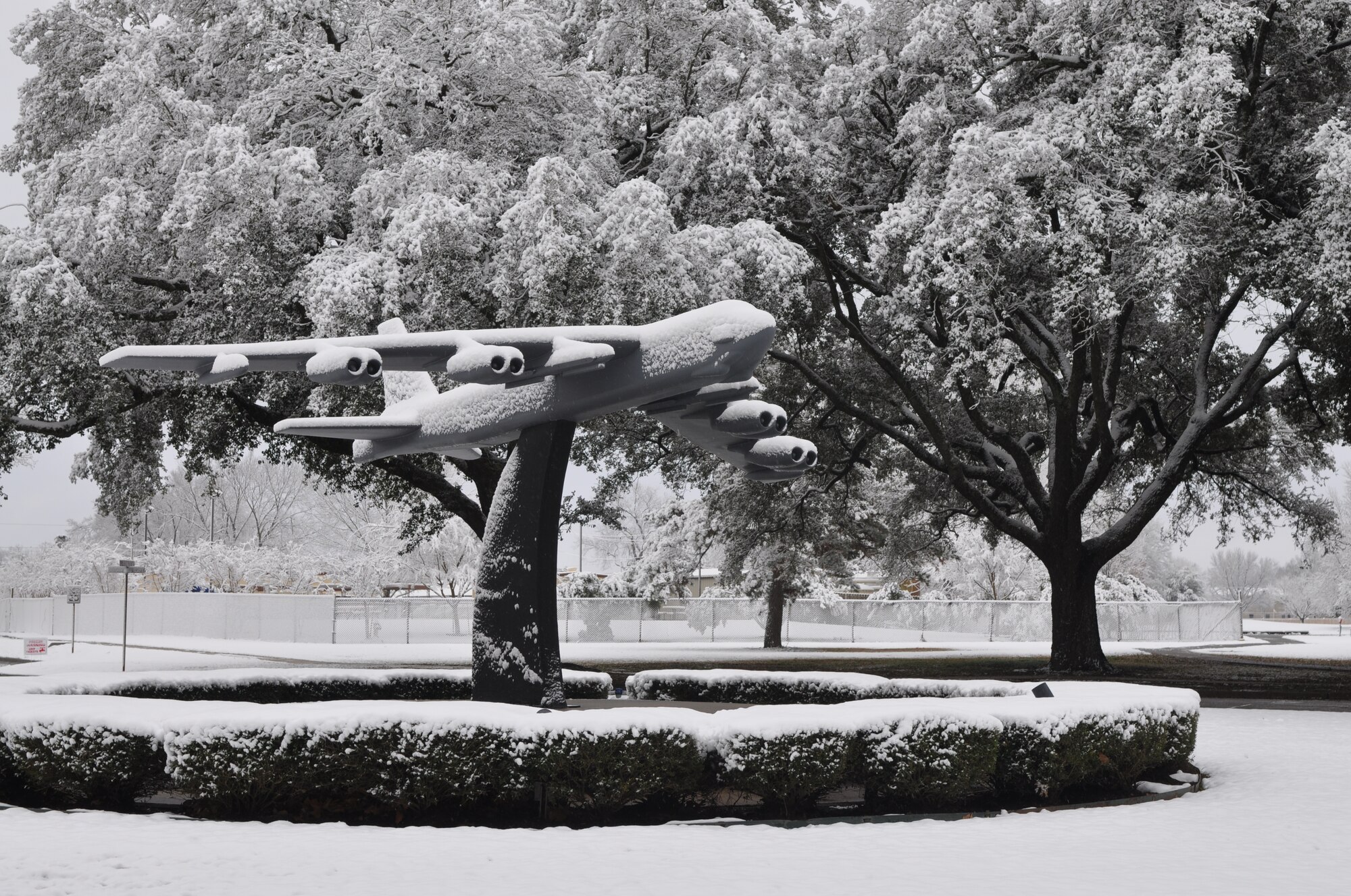 A B-52 Stratofortress sculpture at the main entrance to Barksdale Air Force Base, La., is camouflaged into the trees by snow on Feb. 12, 2010. Barksdale, disguised in two-and-a-half inches of snow, opened its gates after 10 a.m. due to the snowfall throughout the night. This coating is the first in over five years for the Barksdale, which houses the 917th Wing. (U.S. Air Force Photo/Tech. Sgt. Jeffrey Walston)