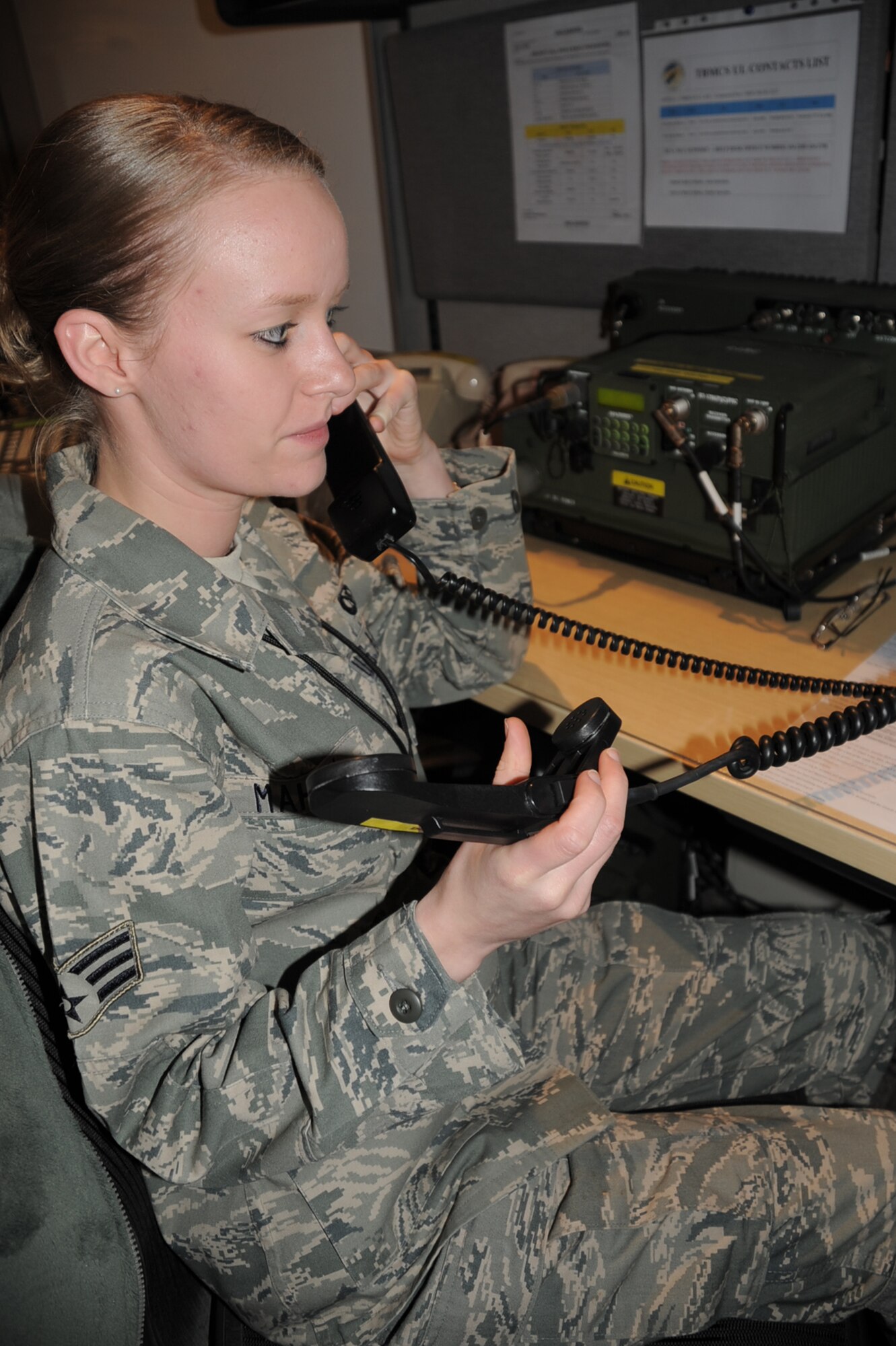 Senior Airman Casey Mahan, command post journeyman for the 380th Air Expeditionary Wing Command Post, works in her office at a non-disclosed base in Southwest Asia on Feb. 3, 2010. Airman Mahan is deployed from the 90th Missile Wing Command Post at F.E. Warren Air Force Base, Wyo., and her hometown is Perryville, Ark. (U.S. Air Force Photo/Master Sgt. Scott T. Sturkol/Released)