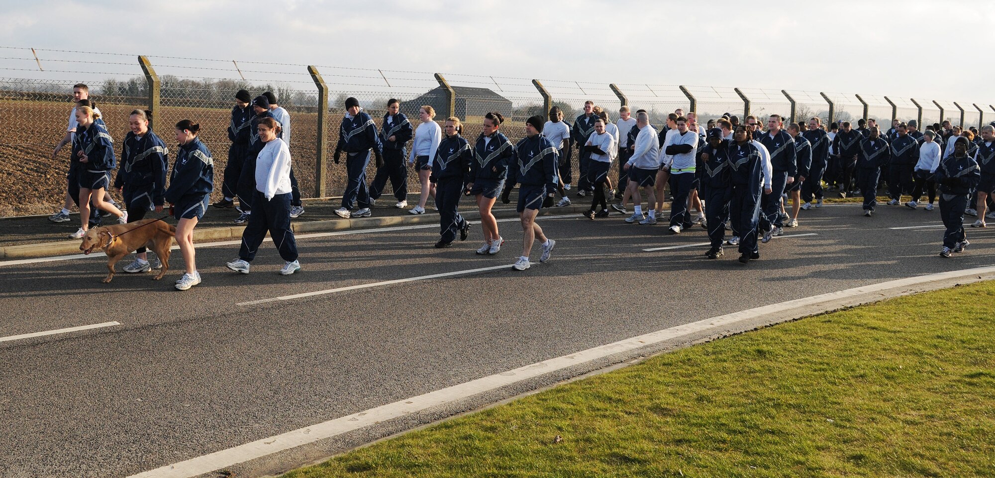 RAF MILDENHALL, England -- RAF Mildenhall Airman and their friends, family and pets walk to the starting line of the Team Mildenhall 5K Fun Run near the Hardstand Fitness Center Feb. 19. Hundreds of 100th Air Refueling Wing and tenant unit Airmen participated in the monthly run. Families, friends and even pets were encouraged to attend to promote health and fitness. (U.S. Air Force photo/Senior Airman Thomas Trower) 