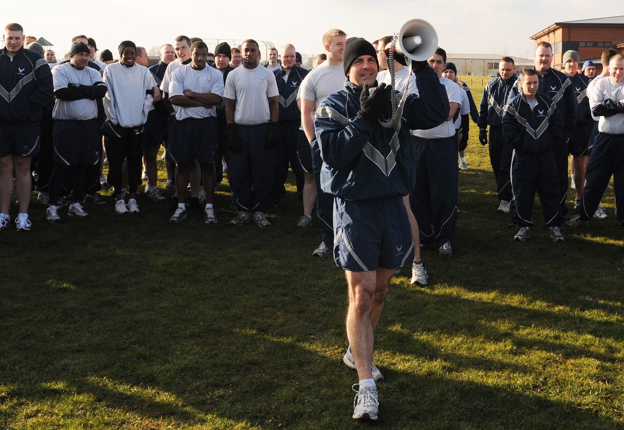 RAF MILDENHALL, England -- Col. Chad Manske, 100th Air Refueling Wing commander, encourages runners to try their best at the Team Mildenhall 5K Fun Run near the Hardstand Fitness Center Feb. 19. Hundreds of 100th Air Refueling Wing and tenant unit Airmen participated in the monthly run. (U.S. Air Force photo/Senior Airman Thomas Trower)