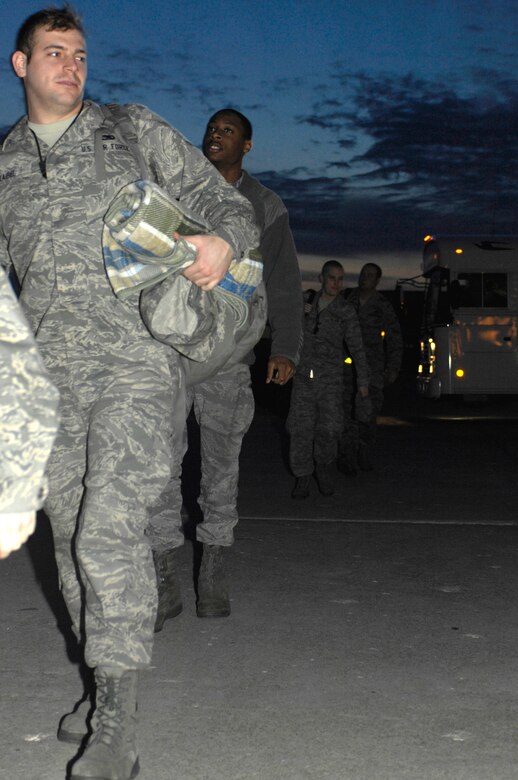 WHITEMAN AIR FORCE BASE, Mo. - More than 200 Team Whiteman members exit a bus Feb. 18, 2010 here, en-route to Andersen AFB, Guam. The Airmen deployed in support of the B-2 Spirit's continuing bomber-presence in the Pacific. (U.S. Air Force photo/Staff Sgt. Jason Barebo)