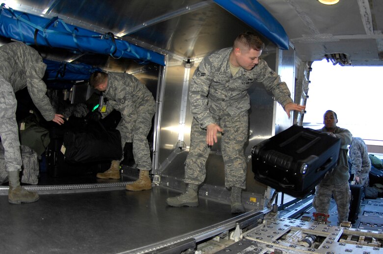 WHITEMAN AIR FORCE BASE, Mo. - Team Whiteman members load luggage Feb. 18, 2010 here, on an aircraft headed for Andersen AFB, Guam. More than 200 Airmen deployed in support of the B-2 Spirit's continuing bomber presence in the Pacific. (U.S. Air Force photo/Staff Sgt. Jason Barebo)