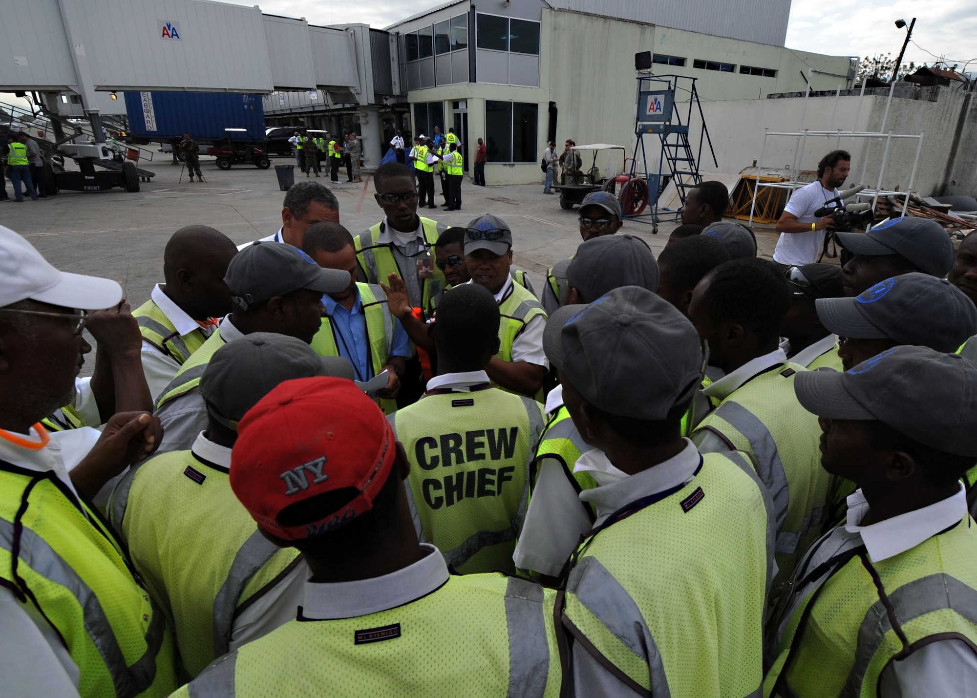 Workers at Toussaint Louverture International Airport in Port-au-Prince, Haiti prepare to receive an American Airlines aircraft. The flight, from Miami, was the first commercial airline flight since a 7.0 magnitude earthquake caused severe damage in and around Port-au-Prince Jan. 12. (U.S. Navy photo by Senior Chief Mass Communication Specialist Spike Call/Released)