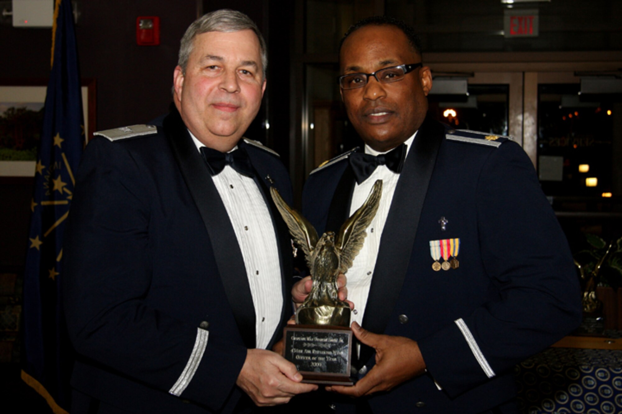 GRISSOM AIR RESERVE BASE, Ind. -- Chaplain (Maj.) Obadiah Smith, 434th Air Refueling Wing chaplain, receives a trophy in recognition for being named 434th ARW Officer of the Year from Brig. Gen. Dean Despinoy, 434th ARW commander. Trophies and recognition were given out during the annual awards banquet held recently at the base dining facility. Military personnel, Grissom Community Council members and families were in attendance. (U.S. Air Force photo/Tech. Sgt. Mark. R. W. Orders-Woempner)