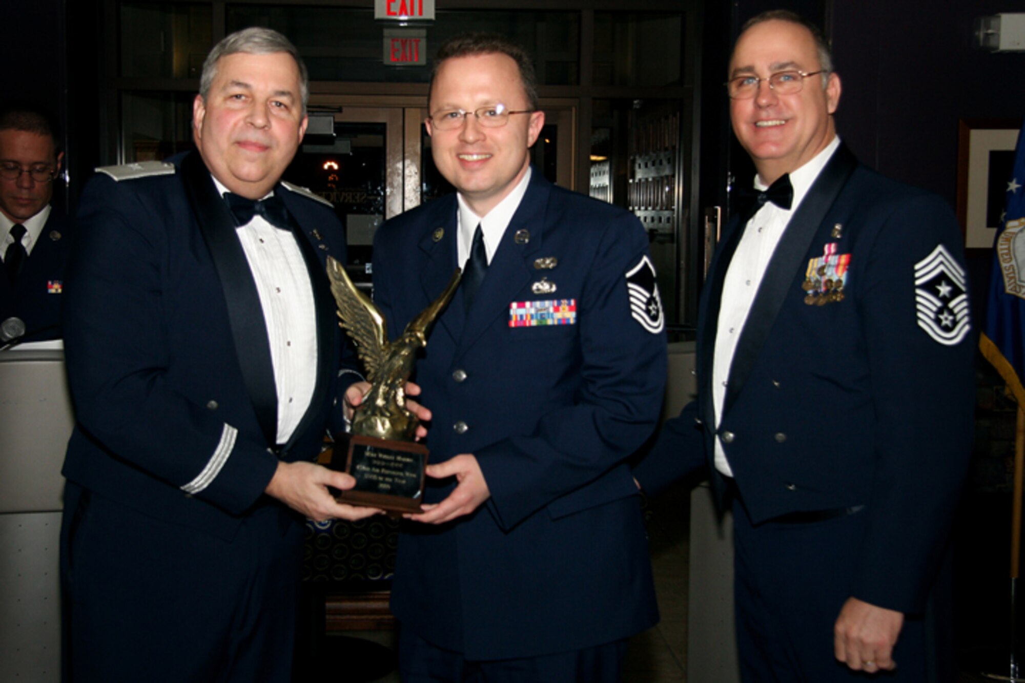 GRISSOM AIR RESERVE BASE, Ind. -- Master Sgt. Wes Marion, 434th Air Refueling Wing legal office superintendent, receives a trophy in recognition for being named 434th Air Refueling Wing Senior Noncommissioned Officer of the Year from Brig. Gen. Dean Despinoy, 434th ARW commander, and Chief Master Sgt. Larry Brady, 434th ARW command chief. Trophies and recognition were given out during the annual awards banquet held recently at the base dining facility. Military personnel, Grissom Community Council members and families were in attendance. (U.S. Air Force photo/Tech. Sgt. Mark. R. W. Orders-Woempner)