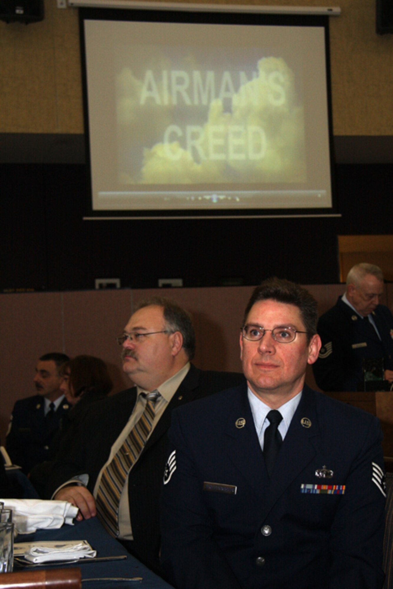 GRISSOM AIR RESERVE BASE, Ind. -- Staff Sgt. Joseph Schluttenhofer, 434th Air Refueling Wing pay technician, watches a video of the Airman's Creed during Grissom's recent annual awards banquet. The event honored 434th ARW annual award winners and was held at the Grissom dining facility. (U.S. Air Force photo/Tech. Sgt. Mark. R. W. Orders-Woempner)