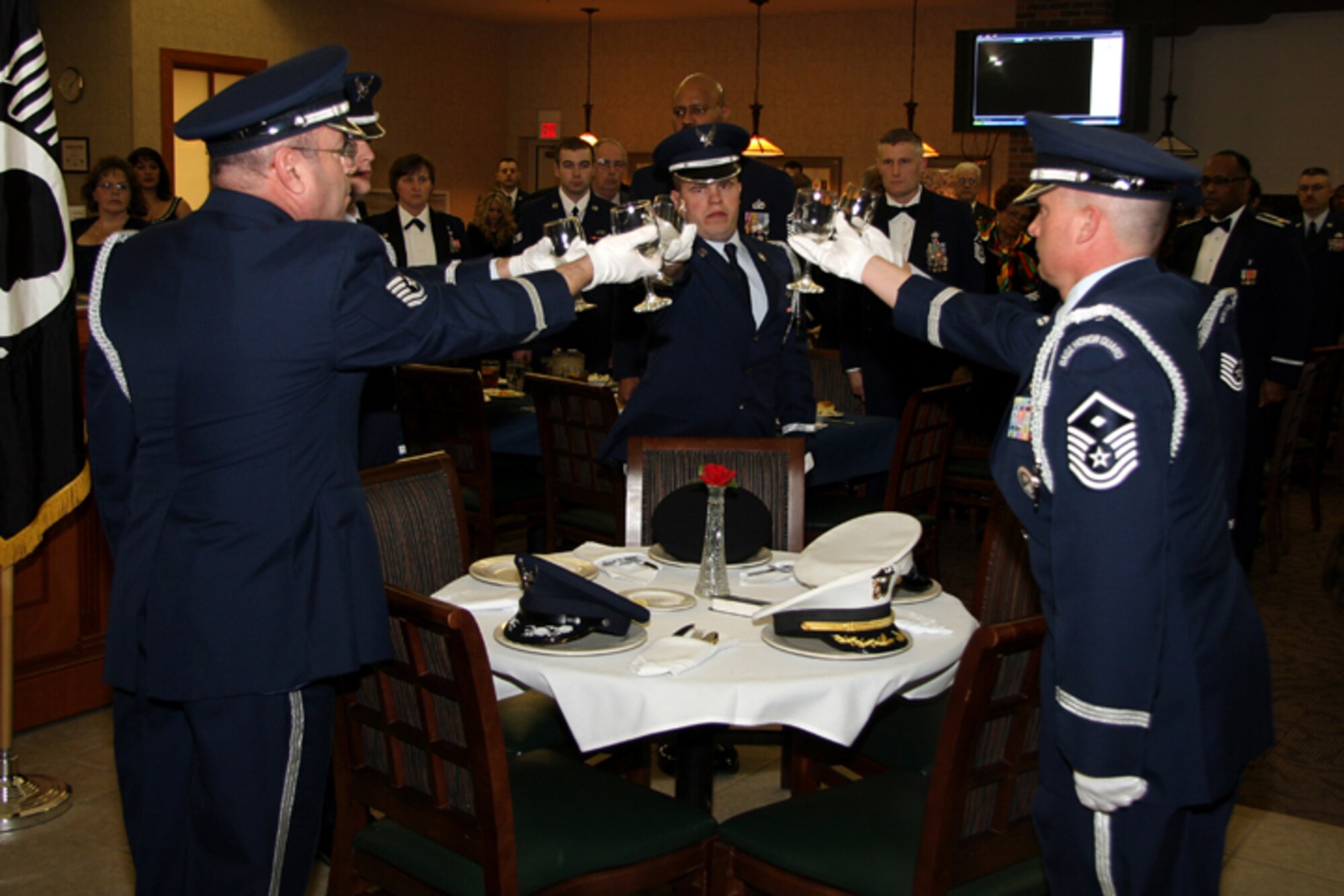 GRISSOM AIR RESERVE BASE, Ind. -- Members of the Grissom Base Honor Guard raise glasses in honor of prisoners of war and those missing in action during a POW/MIA ceremony held during the opening ceremonies of the annual awards banquet held at Grissom ARB. The banquet honored 434th Air Refueling Wing annual award winners and was held at the Grissom dining facility. (U.S. Air Force photo/Tech. Sgt. Mark. R. W. Orders-Woempner)