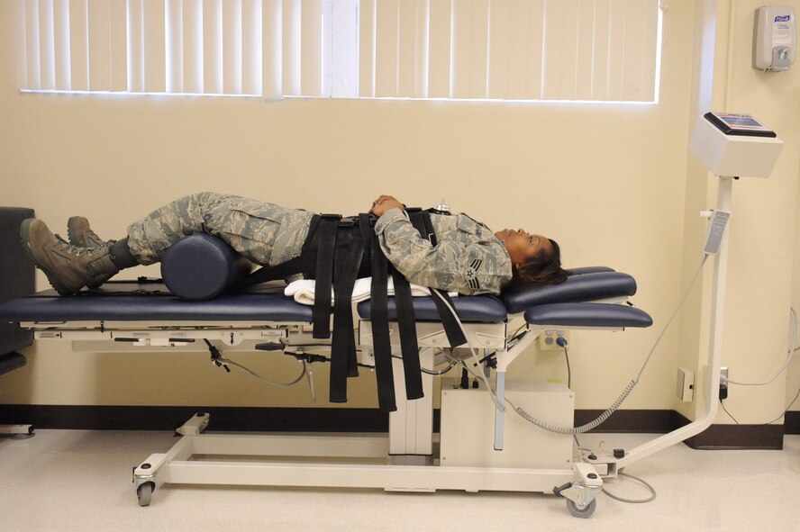 Senior Airman Patrice Castille, 4th Logistics Readiness Squadron material management, lies on a traction table to stretch her back during physical therapy on Seymour Johnson Air Force Base, N.C., Feb 19, 2010. The traction table rehabilitates patients with lower back pain. Castille hails from Hampton, Va. (U.S. Air Force photo/Senior Airman Whitney Lambert)