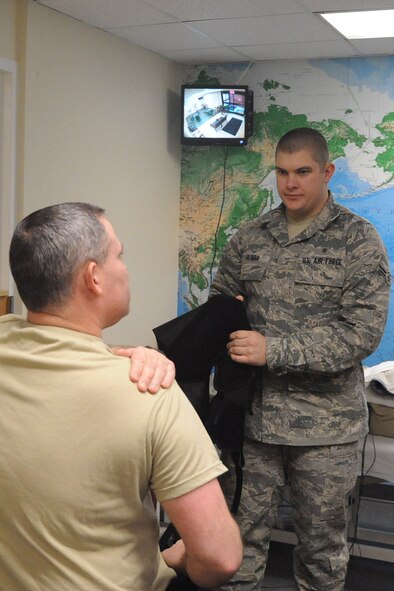 Airman 1st Class Randy Slaba, 4th Medical Group physical therapy technician, asks Master Sgt. Jeffery Arnold, 4th Communication Squadron superintendent wing communication section office, if his pain level decreases or increases after stretching at Seymour Johnson Air Force Base, N.C., Feb 19, 2010. Physical therapy technicians ask patients about their pain level to determine if physical therapy is helping.  Arnold's shoulder movement has improved after weeks of physical therapy following surgery. Arnold is from Milan, Ill. and Slaba is from North Platte, Nev. (U.S. Air Force photo/Senior Airman Whitney Lambert) 