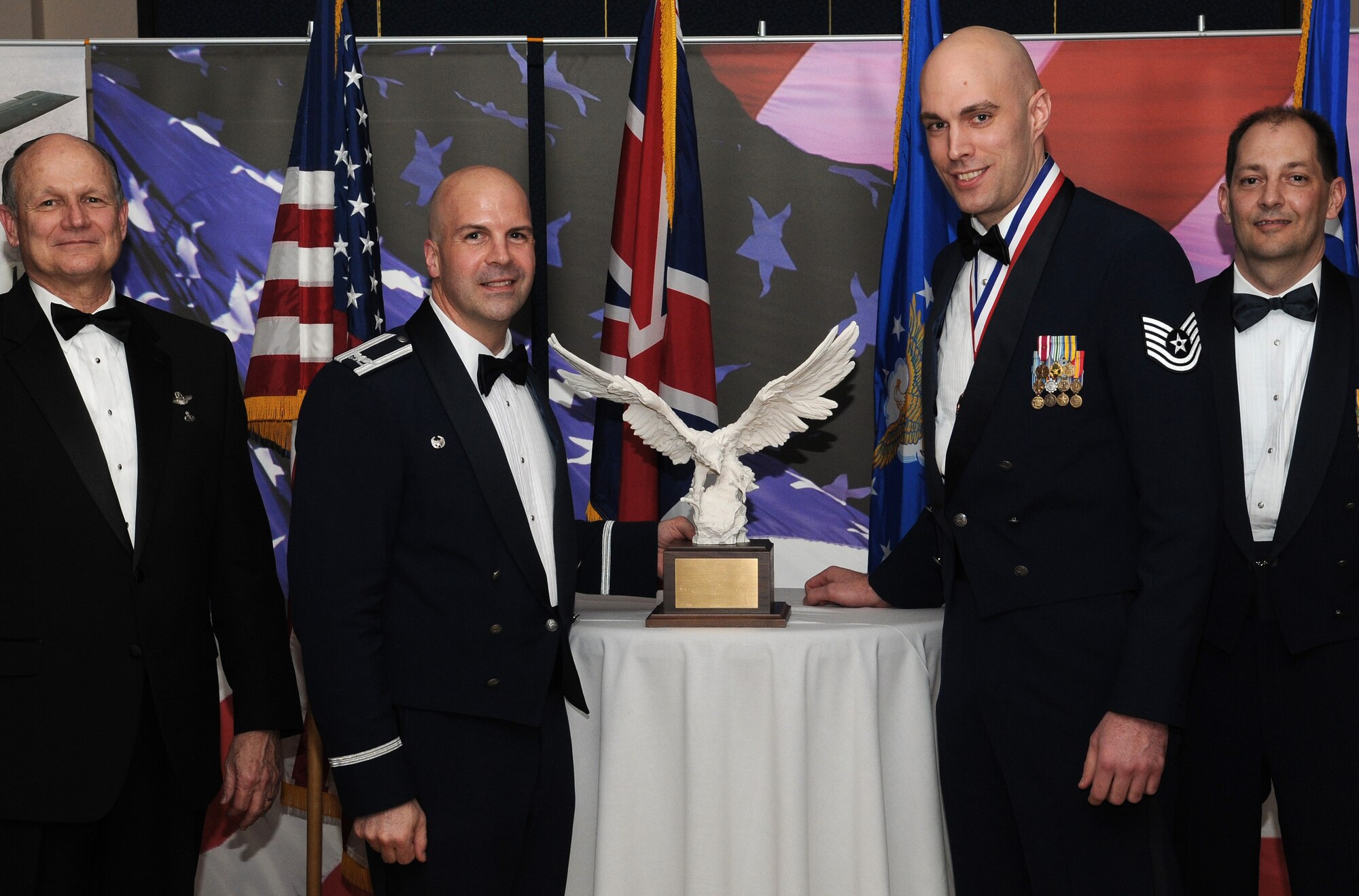 RAF MILDENHALL, England -- Tech. Sgt. Joshua Franklin, 100th Air Refueling Wing Safety, is the 100th ARW and Team Mildenhall 2009 NCO of the Year. His achievements included identifying 113 hazards among 13 deployed units. He also served as chairman for the World War II Veteran's Council in Kyrgyzistan. He is presented this award by retired Gen. Gregory Martin, Col. Chad Manske, 100th ARW commander, and Chief Master Sgt. Antonio Hickey, 100th ARW command chief. (U.S. Air Force photo/Senior Airman Thomas Trower)