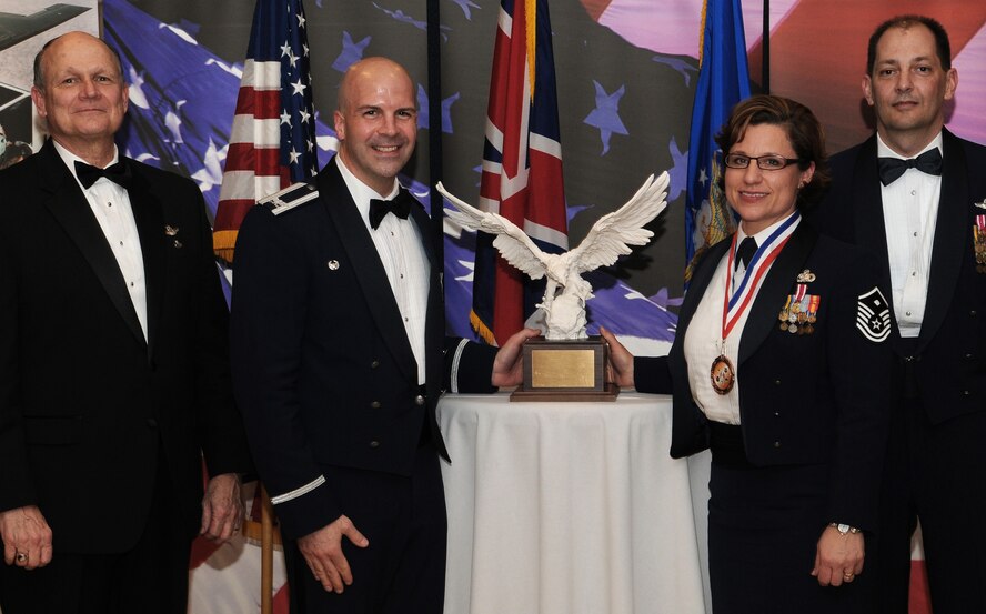 RAF MILDENHALL, England -- Master Sgt. Hayden Pickett, 100th Communications Squadron first sergeant, is the 100th Air Refueling Wing and Team Mildenhall 2009 First Sergeant of the Year. Her achievements include leading four self-help projects for 100th CS dorm improvements and running 11 Diamond Sharp presentations. She also worked with 35 deployed Airmen to plant about 1,000 trees in support of Earth Day. She is presented this award by retired Gen. Gregory Martin, Col. Chad Manske, 100th ARW commander, and Chief Master Sgt. Antonio Hickey, 100th ARW command chief. (U.S. Air Force photo/Senior Airman Thomas Trower) 