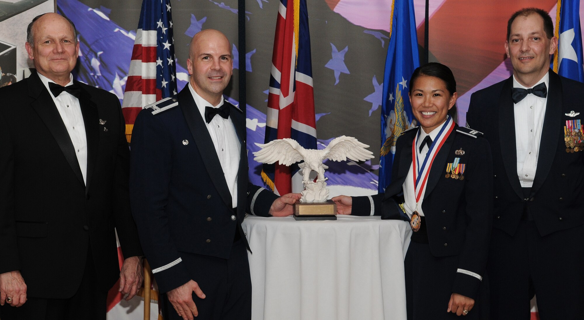 RAF MILDENHALL, England -- Capt. Meera Noe, 100th Communications Squadron, is the 100th Air Refueling Wing 2009 Company Grade Officer of the Year. Her accomplishments include aiding in a Russian helicopter crash response and planning a memorial service for 16 civilians. She also distributed 150 boxes of toiletries, clothes, supplies and medication to Afghan women and children. She is presented this award by retired Gen. Gregory Martin, Col. Chad Manske, 100th Air Refueling Wing commander, and Chief Master Sgt. Antonio Hickey, 100th ARW command chief. (U.S. Air Force photo/Senior Airman Thomas Trower)