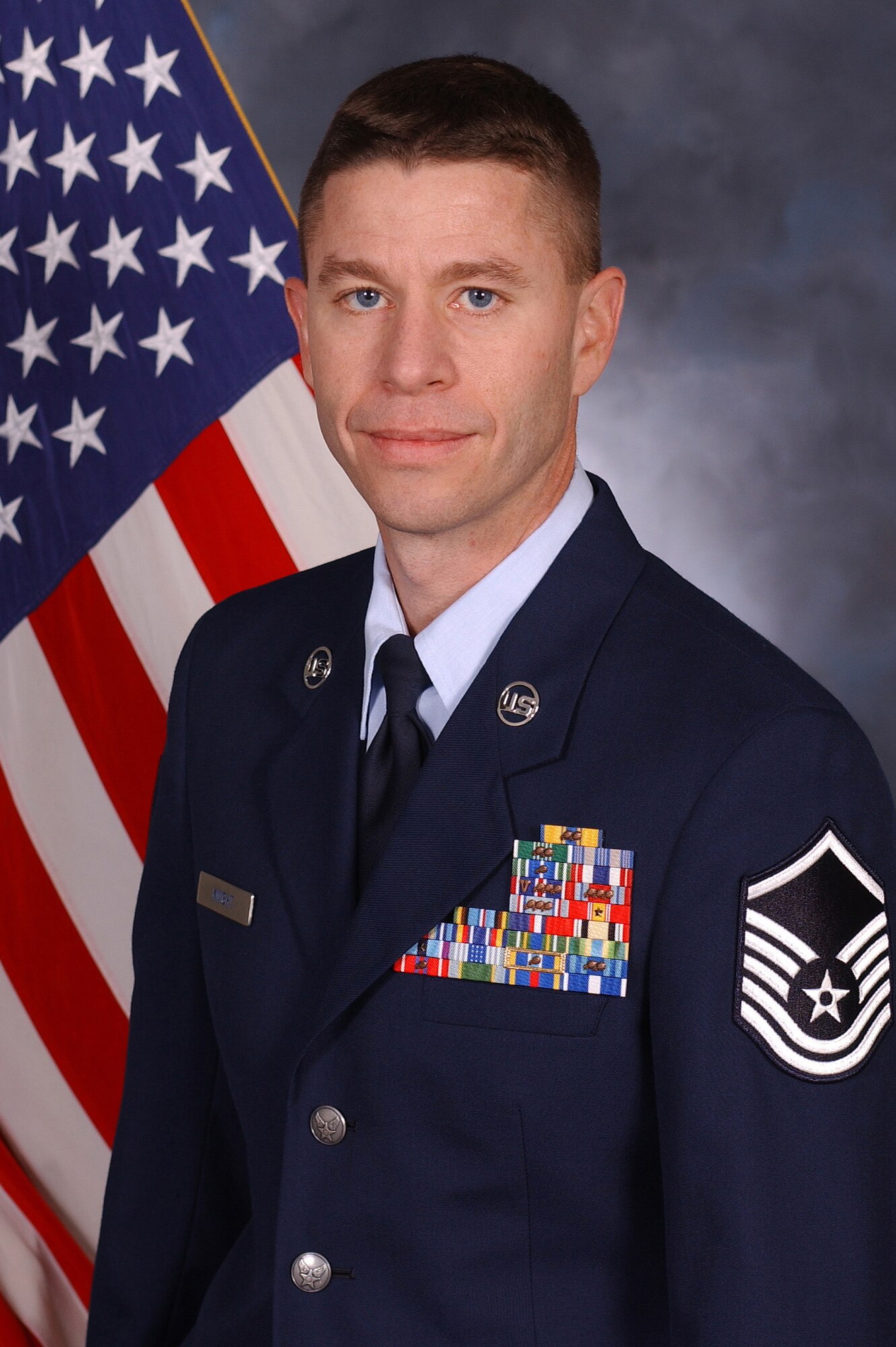 RAF MILDENHALL, England -- Master Sgt. Fambro Knight, 100th Operations Support Squadron Weather Flight, is the 100th Air Refueling Wing and Team Mildenhall 2009 Senior NCO of the Year. His achievements include coordinating weather support for the space shuttle. He also led a toy drive to collect more than 400 gifts for special needs children. He is presented this award by retired Gen. Gregory Martin, Col. Chad Manske, 100th Air Refueling Wing commander, and Chief Master Sgt. Antonio Hickey, 100th ARW command chief. (U.S. Air Force photo/Senior Airman Thomas Trower)                  