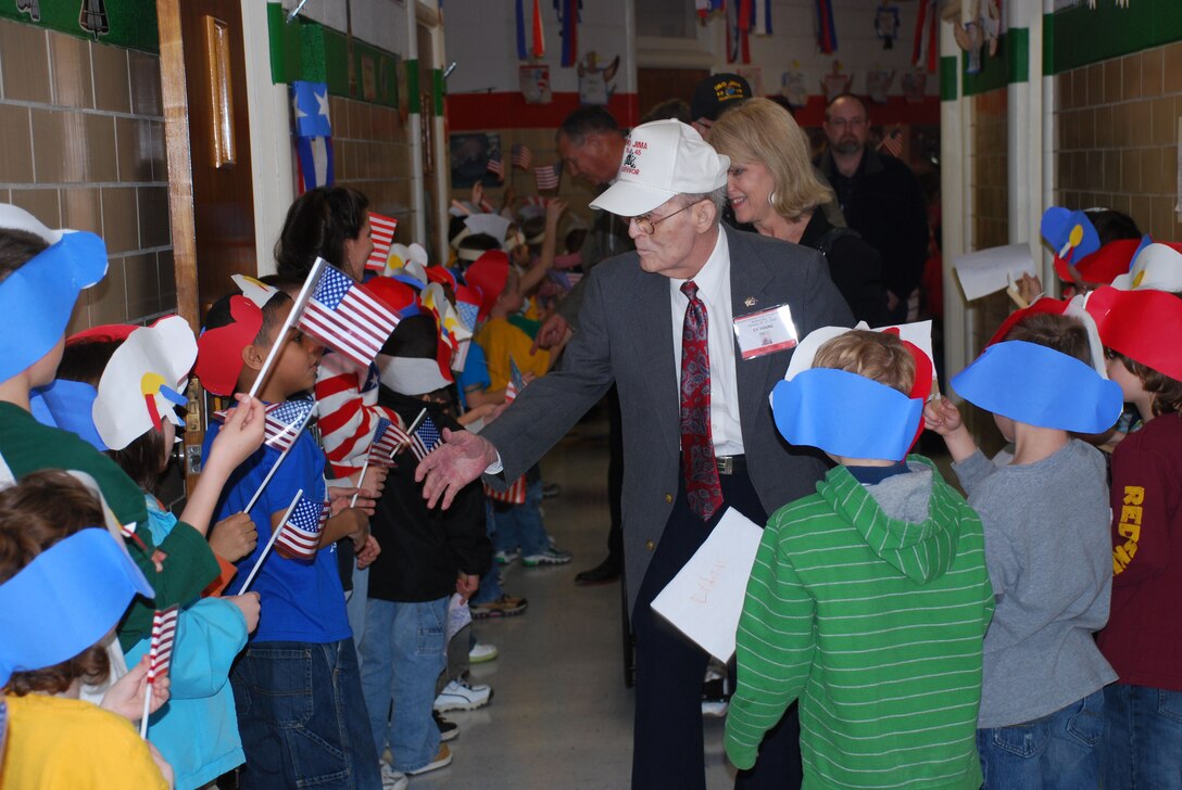 Iwo Jima survivors greet students during the Iwo Jima Survivors Reunion Luncheon at Sheppard Elementary School Feb. 19. The students honored he veterans with a musical tribute after the luncheon. (U.S. Air Force photo/Debi Smith)