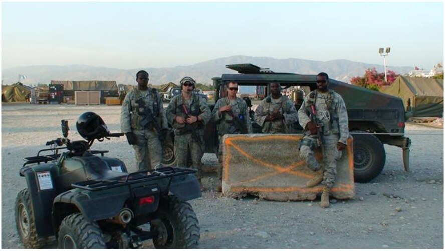 PORT-AU-PRINCE, Haiti -- Airmen from the 823rd Expeditionary Security Forces Squadron stand in front of their tactical vehicles at the Toussaint L'Ouverture International Airport here. (Courtesy photo)