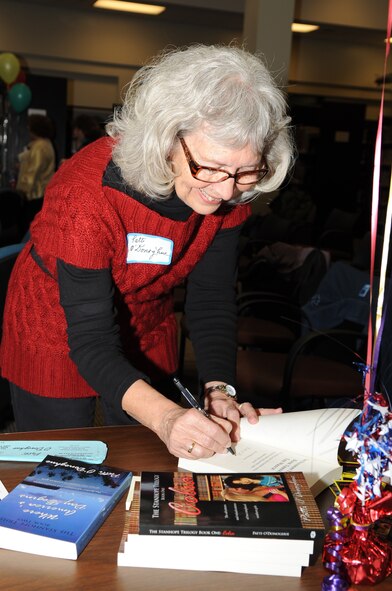 Patti O'Donoghue, author of "The Stanhope Trilogy," autographs one of her books during a Meet the Author book signing on Seymour Johnson Air Force Base, Feb. 18, 2010. O'Donoghue and three other writers came to the base book signing to explain their storylines and how their life experiences shaped them. O'Donoghue, a 33-year Air Force spouse, started her writing career as a freelance journalist in Goldsboro, N.C. (U.S. Air Force photo/Staff Sgt. Courtney Richardson)