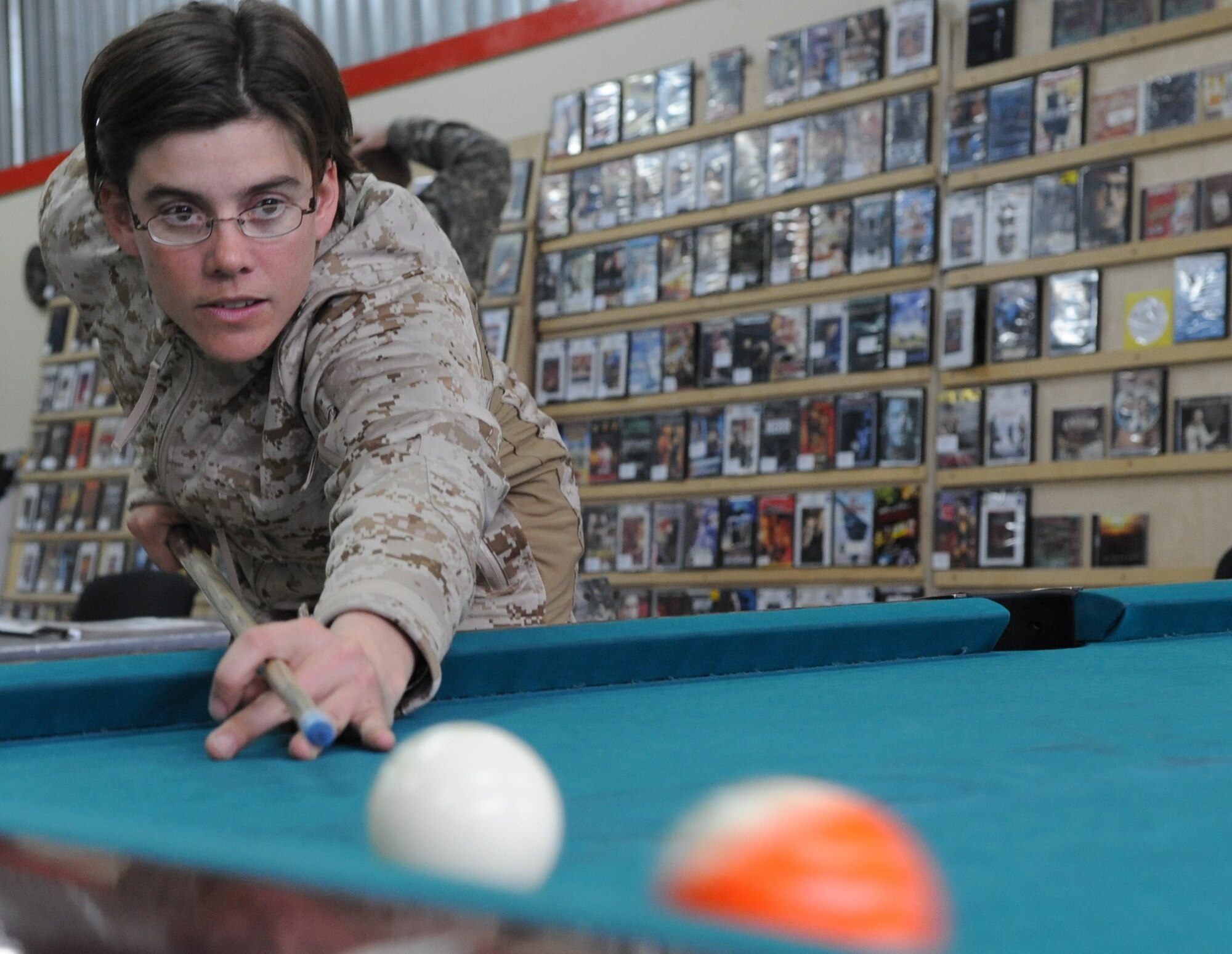 U.S. Navy Lt. Cmdr. Nicole Del Pidio, emergency medical doctor, shoots pool at "Shooters," a recreational center at the Transit Center at Manas, Kyrgyzstan, Feb. 19, 2010. She is en route to a forward operating base in Afghanistan to augment the U.S. Marine Corps. (U.S. Air Force photo/Senior Airman Nichelle Anderson/released). 