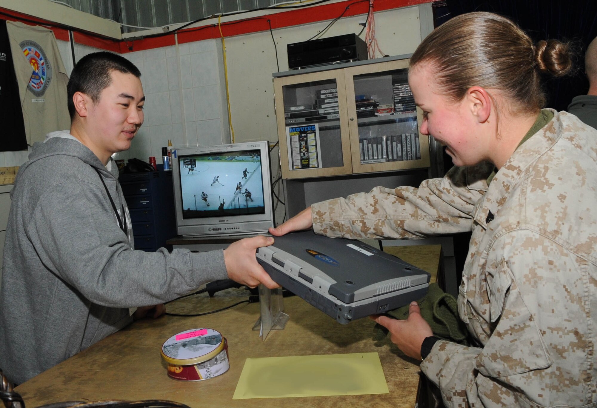 U.S. Marine Cpl. Julie Nicholson checks out a laptop computer at "Shooters," a recreational center at the Transit Center at Manas, Kyrgyzstan, Feb. 19, 2010. Corporal Nicholson is a supply administrator and is headed to a forward operating base in Afghanistan. (U.S. Air Force photo/Senior Airman Nichelle Anderson/released). 