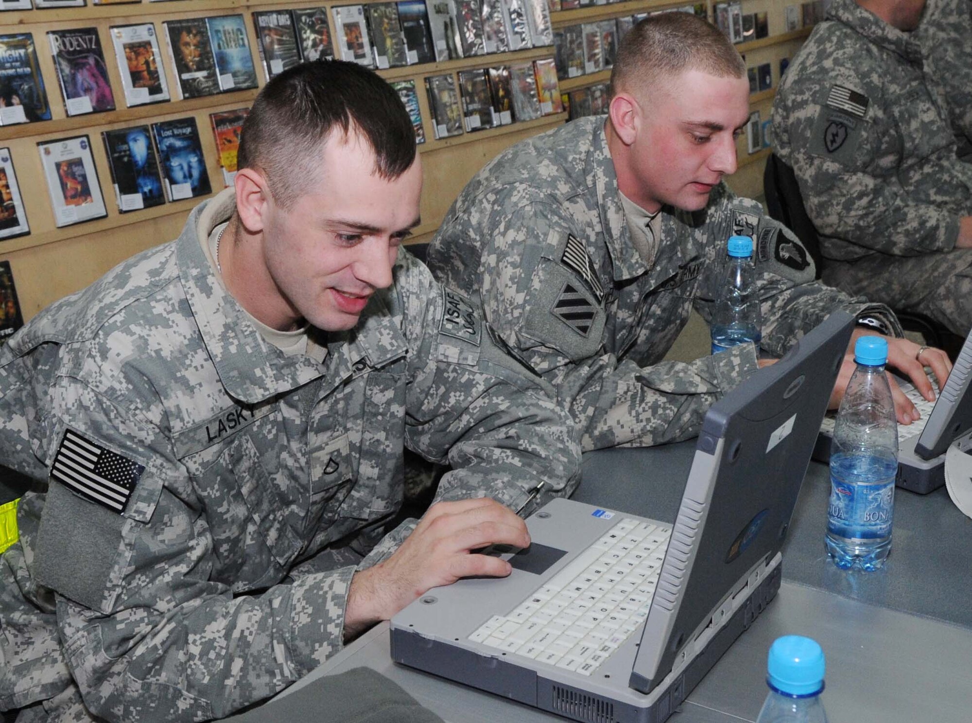 U.S. Army Pfc. Nick Lasky and Spc. Jimmy Minor surf the internet on laptop computers provided by ?Shooters,? a recreational facility at the Transit Center at Manas, Kyrgyzstan, Feb. 19, 2010. Both are from the 101st Airborne Division, 626th Brigade Support Battalion, Ft. Campbell, Ky. (U.S. Air Force photo/Senior Airman Nichelle Anderson/released). 