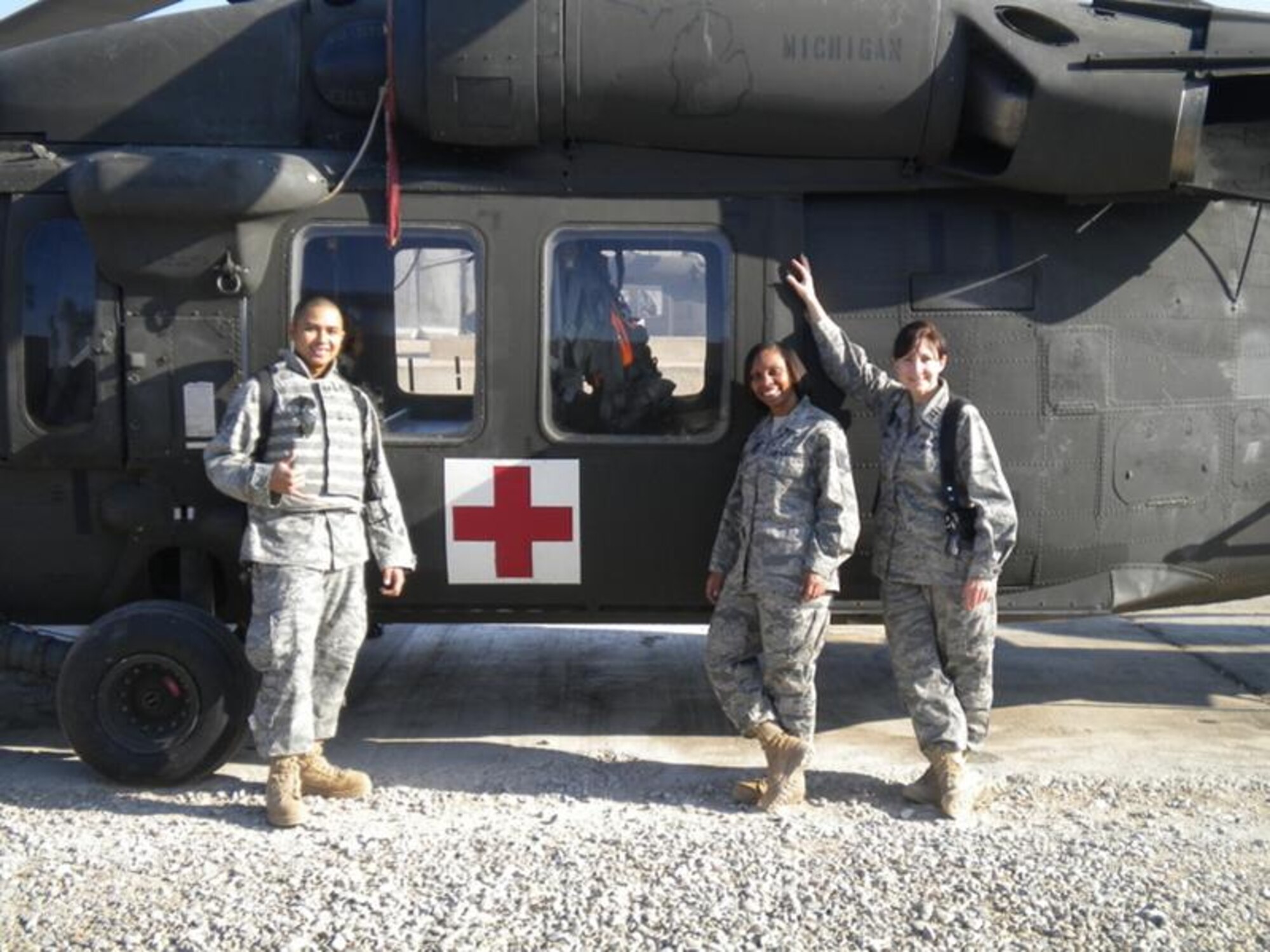 Standing by an Army medical helicopter at Forward Operating Base Echo is Staff Sgt. Bry-wyn Victolero, information management officer; Tech. Sgt. Kathleen Ivey, mental health technician and Capt. Shawna Sperry, psychologist. (Courtesy photo)