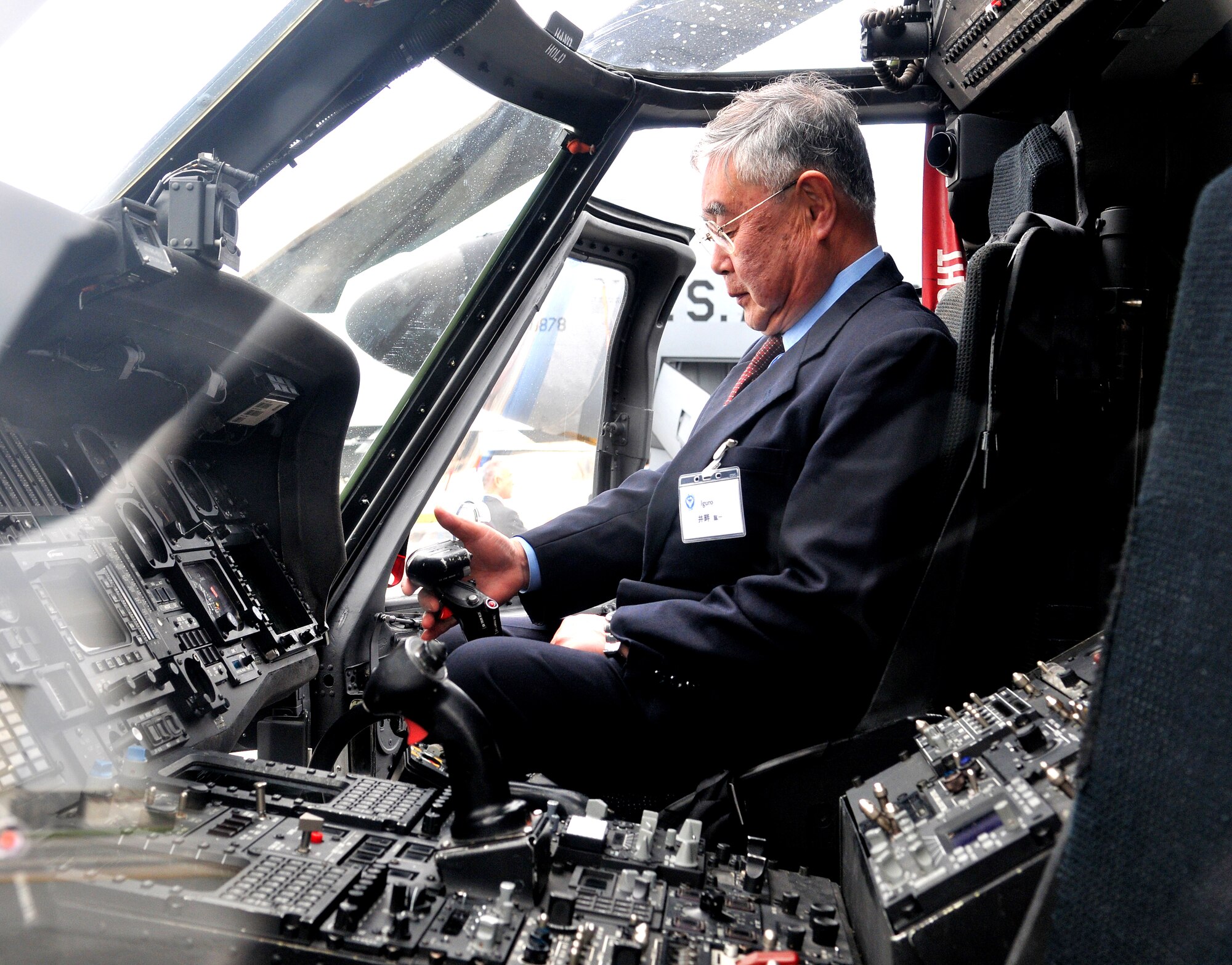 An individual from the Japanese civic leader tour gets into an HH-60 PaveHawk during a tour of the flightline Feb. 19. The group received a mission brief from Brig. Gen. Ken Wilsbach, 18th Wing commander, and were given the opportunity to speak to the aircrew about their aircraft.  (U.S. Air Force photo/Tech. Sgt. Rey Ramon)