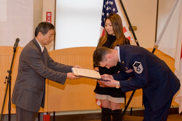 Master Sgt. Michael Wachob, 35th Maintenance Squadron NCO in charge of the consolidated aerospace ground equipment team, at Misawa Air Base, Japan, and his wife, Chitose, accept a Japan-America Air Force Goodwill Association award from Mr. Ikuo Tohtake, Japan Air Self-Defense Force retired general and JAAGA president, Feb. 19, 2010. JAAGA is an organization comprised of primarily JASDF veterans with the goal of promoting friendship and mutual understanding between JASDF and the U.S. Air Force. Each year, JASDF and U.S. Air Force Airmen are recognized for their work in improving bilateral relations. (U.S. Air Force photo/Senior Airman Jamal D. Sutter) 
