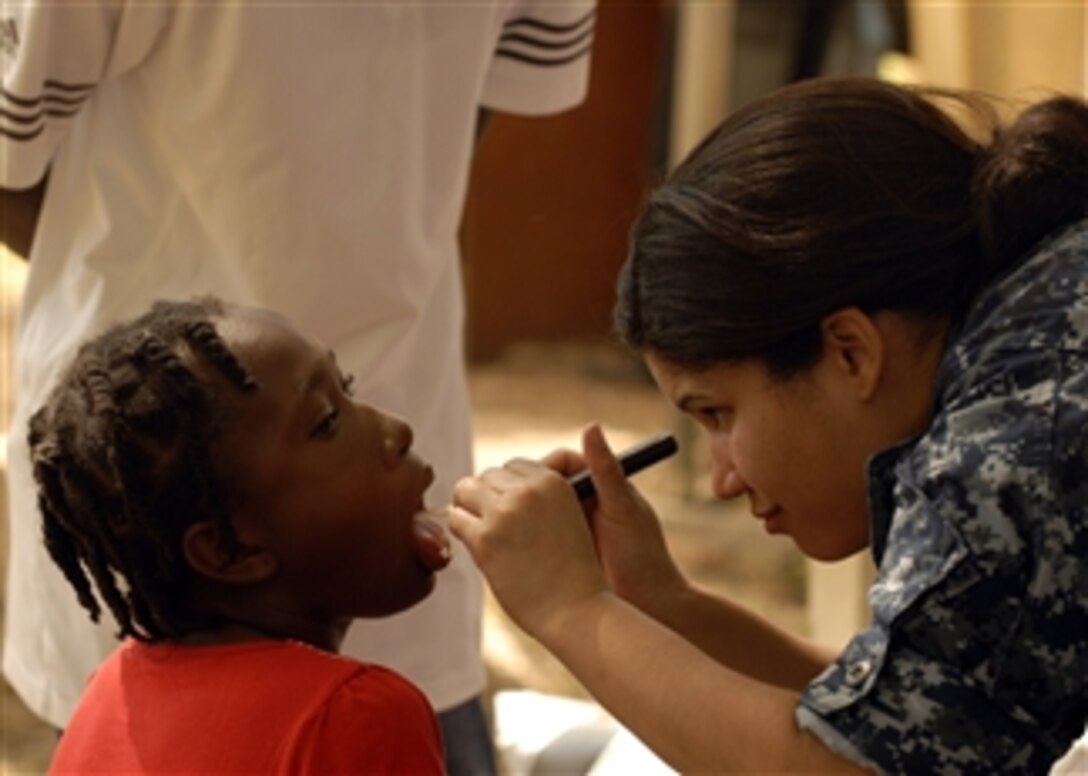 U.S. Navy Lt. Dalia Figueroa, a medical officer aboard the amphibious dock landing ship USS Carter Hall (LSD 50), examines a child at a field treatment camp at Hospital Cardinal Leger in Leogane, Haiti, on Feb. 6, 2010.  The Carter Hall is conducting humanitarian and disaster relief operations as part of Operation Unified Response in the wake of the 7.0-magnitude earthquake that hit Haiti on Jan. 12, 2010 causing severe damage in and around the country's capital city, Port-au-Prince.  