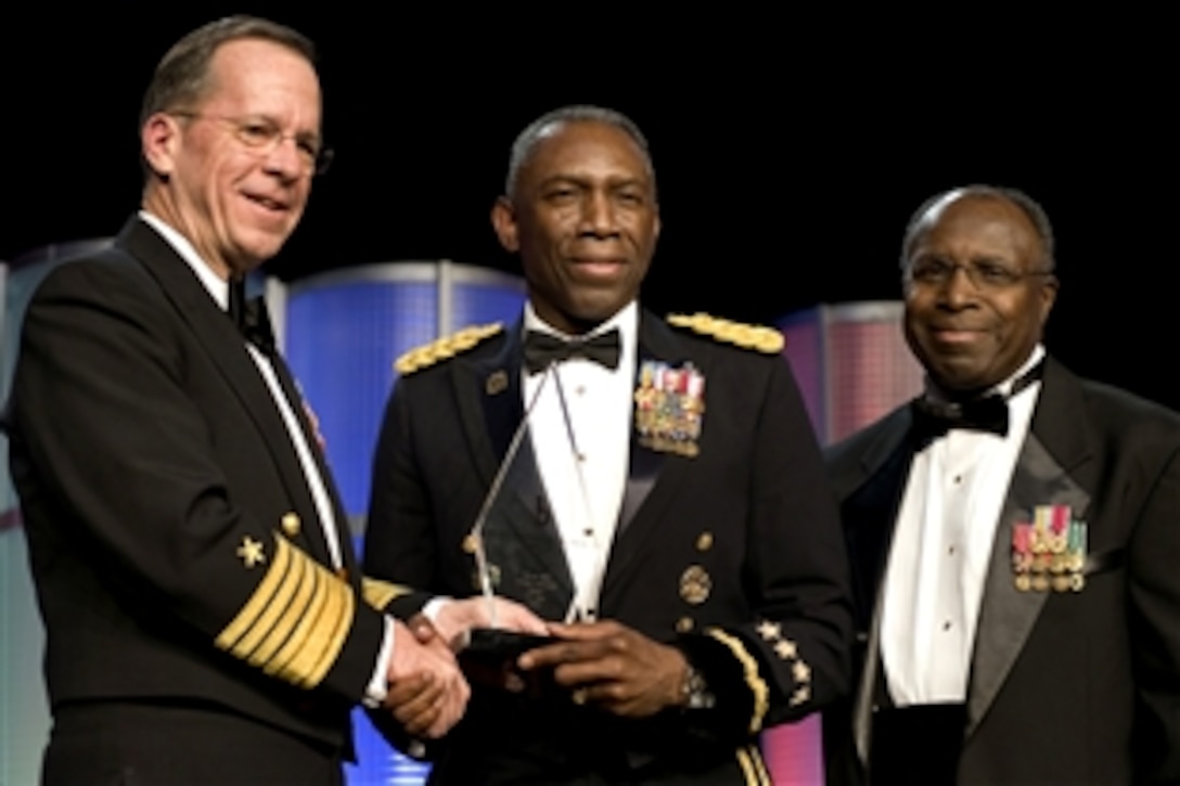 Chairman of the Joint Chiefs of Staff Adm. Mike Mullen, left, and and retired Army Gen. Johnnie E. Wilson, right, present Army Gen. William "Kip" Ward with the Lifetime Achievement Award at the 24th Annual Black Engineer of the Year Awards at a ceremony in Baltimore, Feb. 20, 2010. 
