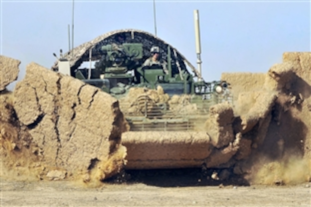 U.S. Army soldiers destroy an abandoned compound near Highway 1 in Hutal, Afghanistan, Feb. 18, 2010. The soldiers are assigned to the 2nd Infantry Division's 2nd Battalion, 1st Infantry Regiment, 5th Stryker Brigade Combat Team.