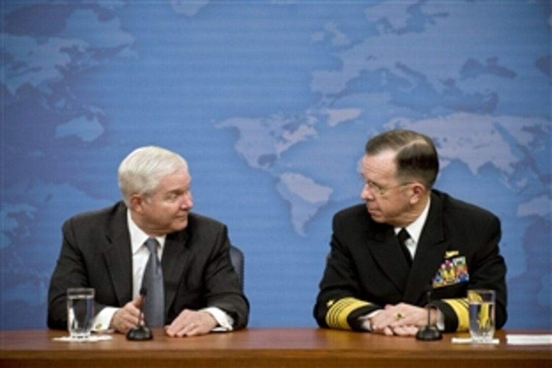 Defense Secretary Robert M. Gates, left, confers with Chairman of the Joint Chiefs of Staff Navy Adm. Mike Mullen while answering questions during a press conference in the Pentagon, Feb. 22, 2010. 


