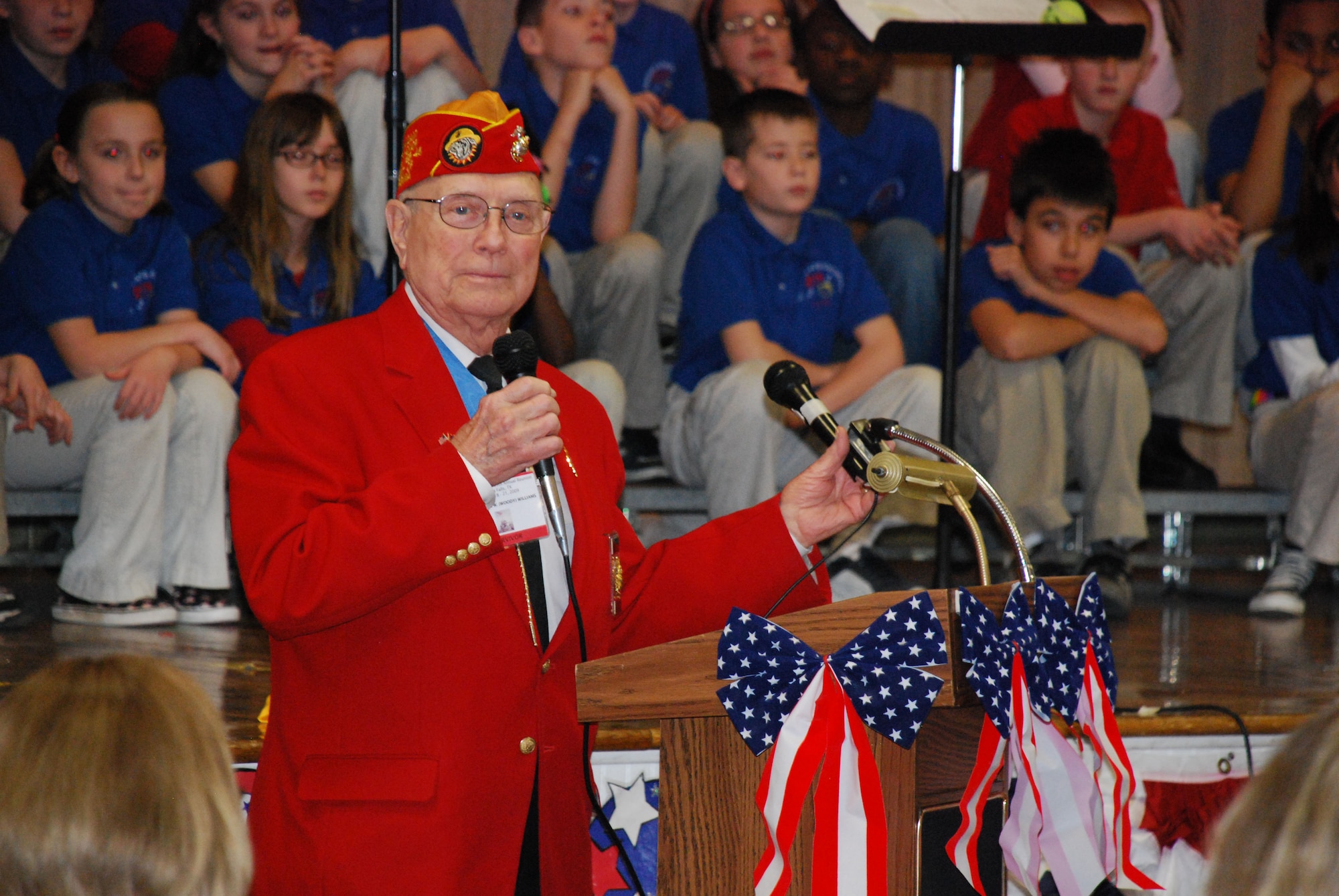 Hershel ?Woody? Williams, an Iwo Jima Medal of Honor recipient, speaks during the Iwo Jima Survivors Reunion Luncheon at Sheppard Elementary School Feb. 19. The students honored the veterans with a musical tribute after the luncheon. (U.S. Air Force photo/Airman 1st Class Valerie Hosea)