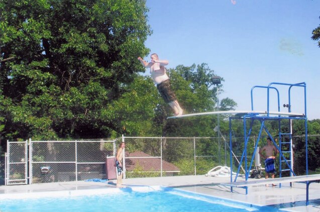 Prior to enlisting in the Marine Corps, Lance Cpl. Clifton Perkins launches off a diving board during the summer of 2007, at which point he weighed in at 310 pounds. He was able to shed more than 100 pounds within a six month window with regular exercise and healthy eating habits.