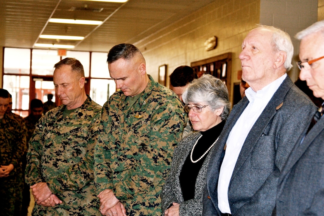 Sgt. Maj. Douglas E. Power, the sergeant major of MWTC, (left), Col. Norman L. Cooling, the commanding officer of MWTC, Marines and family members observe a moment of prayer at the dedication ceremony of the Sgt. Phillip A. Bocks Mountain Leaders Classroom at the multi-purpose building Feb. 22. Bocks, a 28-year-old former Mountain Leaders Course instructor, was killed during combat operations Nov. 9, 2007. His platoon was hit with direct fire from small arms and rocket-propelled grenades from multiple positions during an enemy ambush while returning from a meeting with village elders in Afghanistan’s Nuristan Province, according to the official casualty report.