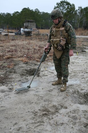A Marine with Military Police Company, Combat Logistics Regiment 27, 2nd Marine Logistics Group, uses a metal detector during a metal detecting course aboard Camp Lejeune, N.C., Feb. 23, 2010.  The Marines attended the course to learn the proper techniques for employing a metal detector in preparation for future deployments to Afghanistan. (U.S. Marine Corps photo by Cpl. M. Bravo)