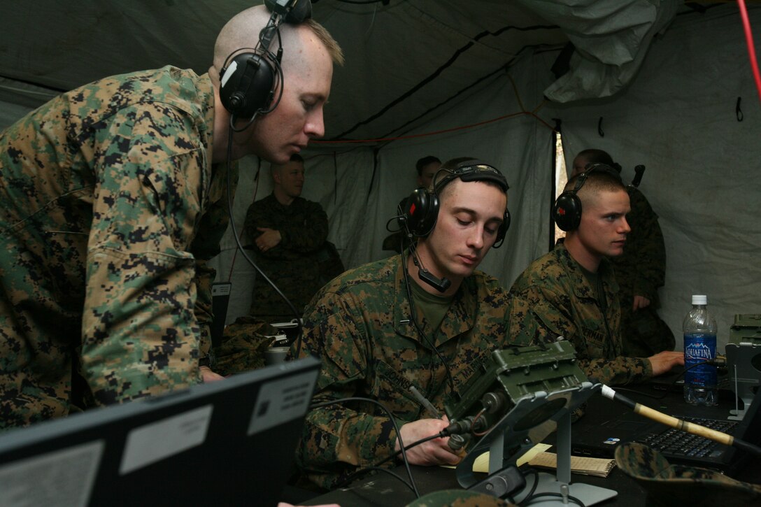 1st Lt. Todd E. Hancock, a tactical aircraft and helicopter director trainer with Marine Air Support Squadron 1, guides 1st Lt. Brian D. Johnson through his procedures during a direct air support squadron exercise, Feb. 23. The tactical air and helicopter director communicates with pilots in the air to coordinate support for troops on the ground.