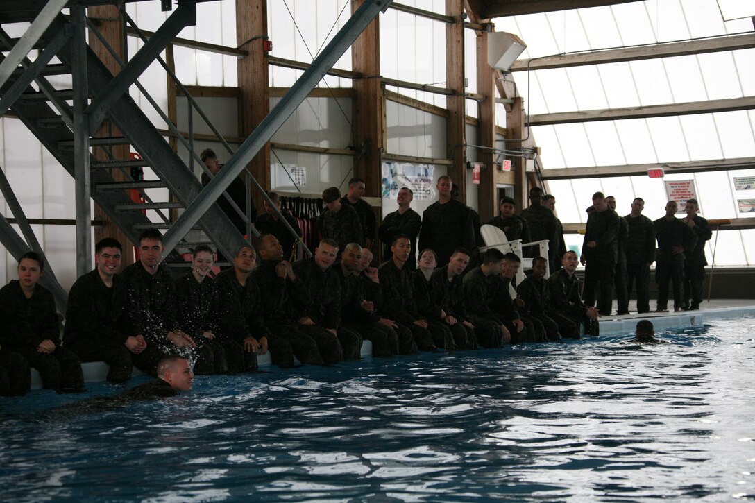 MWHS-2 Marines line the edge of Cherry Point’s combat pool during their annual swim requalifications, Feb. 23.