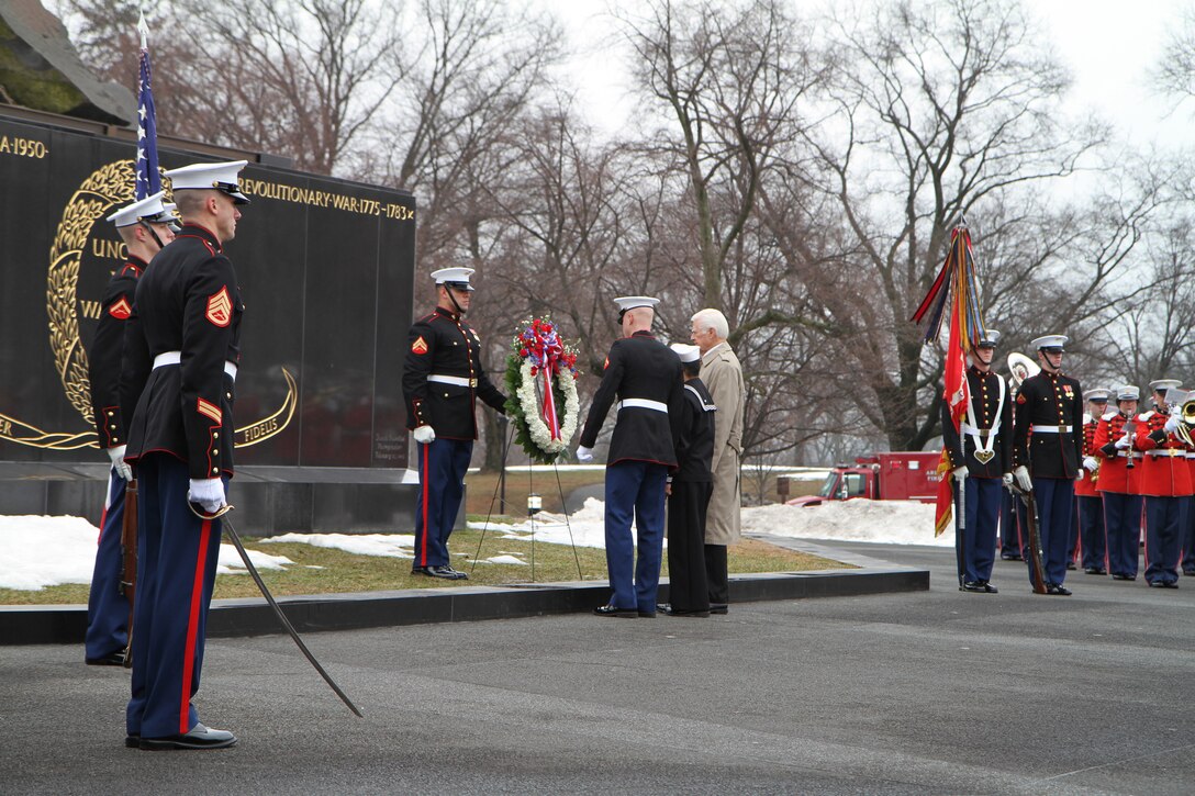 Lance Cpl. Thomas Mooney, Petty Officer 2nd Class Steven Albright and retired Lt. Col. Robert F. Lindholm place a wreath at the foot of the Marine Corps War Memorial during the 65th anniversary wreath laying ceremony, Feb. 23, 2010, in remembrance of the historic Iwo Jima flag-raisings. The ceremony honored the sacrifices of the Marines and sailors who fought the epic battle and the fallen Marines of all wars, to whom the memorial is dedicated.