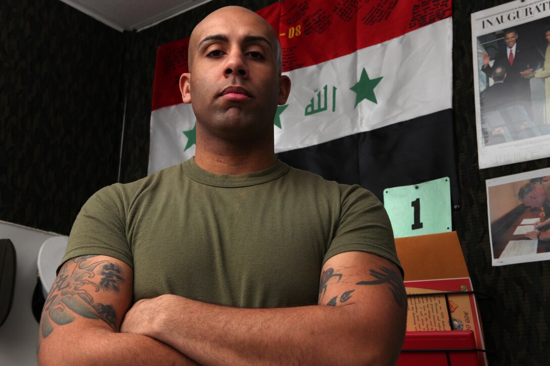 Sgt. Lucien Lewis, a career retention specialist with Headquarters and Service Battalion, Headquarters Marine Corps, poses to show the tattoos on his arms. More than half of Lewis’s tattoos are inspired by his fascination with the Japanese culture, he said. As a career retention specialist, Lewis provides guidance to Marines about future job prospects and how tattoos may hamper those opportunities.