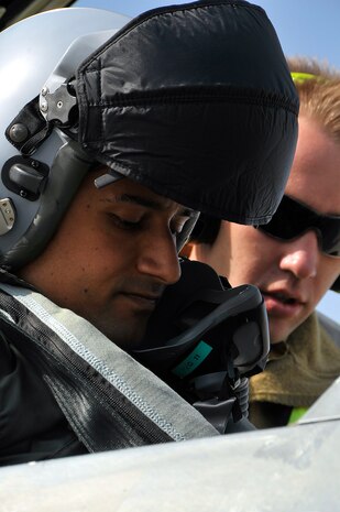 NELLIS AIR FORCE BASE, Nev. -- Flight Lieutenant "Fuzz" Kalantany, 77th Squadron, Royal Australian Air Force, prepares to fly his F/A-18 Hornet with the help of Cpl. James Odea during Red Flag 10-3 Feb. 23. Red Flag is an advanced aerial combat exercise where aircrews from the U.S. and allied nations train in realistic aerial war scenarios over the Nevada Test and Training Range in southern Nevada. (U.S. Air Force photo by Tech. Sgt. Chris Flahive)
