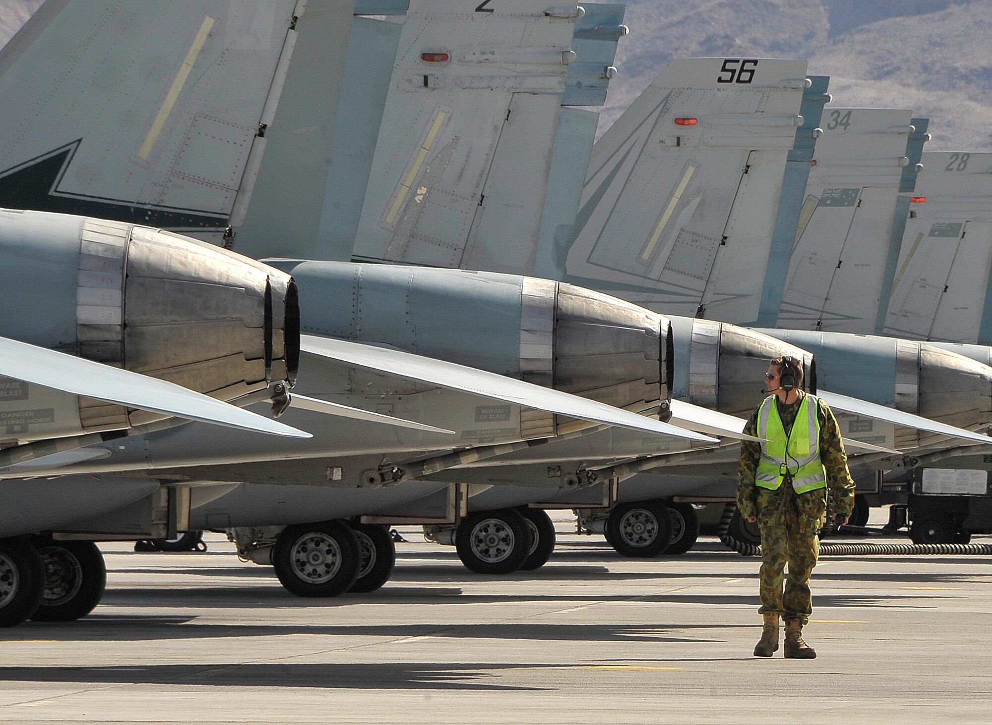 NELLIS AIR FORCE BASE, Nev. -- An airman from the 77th Squadron, Royal Australian Air Force, walks the line visually inspecting the RAAF's F/A-18 Hornets during Red Flag 10-3 Feb. 23. The 77th Squadron is deployed to Nellis from RAAF Base Williamtown, Australia. (U.S. Air Force photo by Tech. Sgt. Chris Flahive)