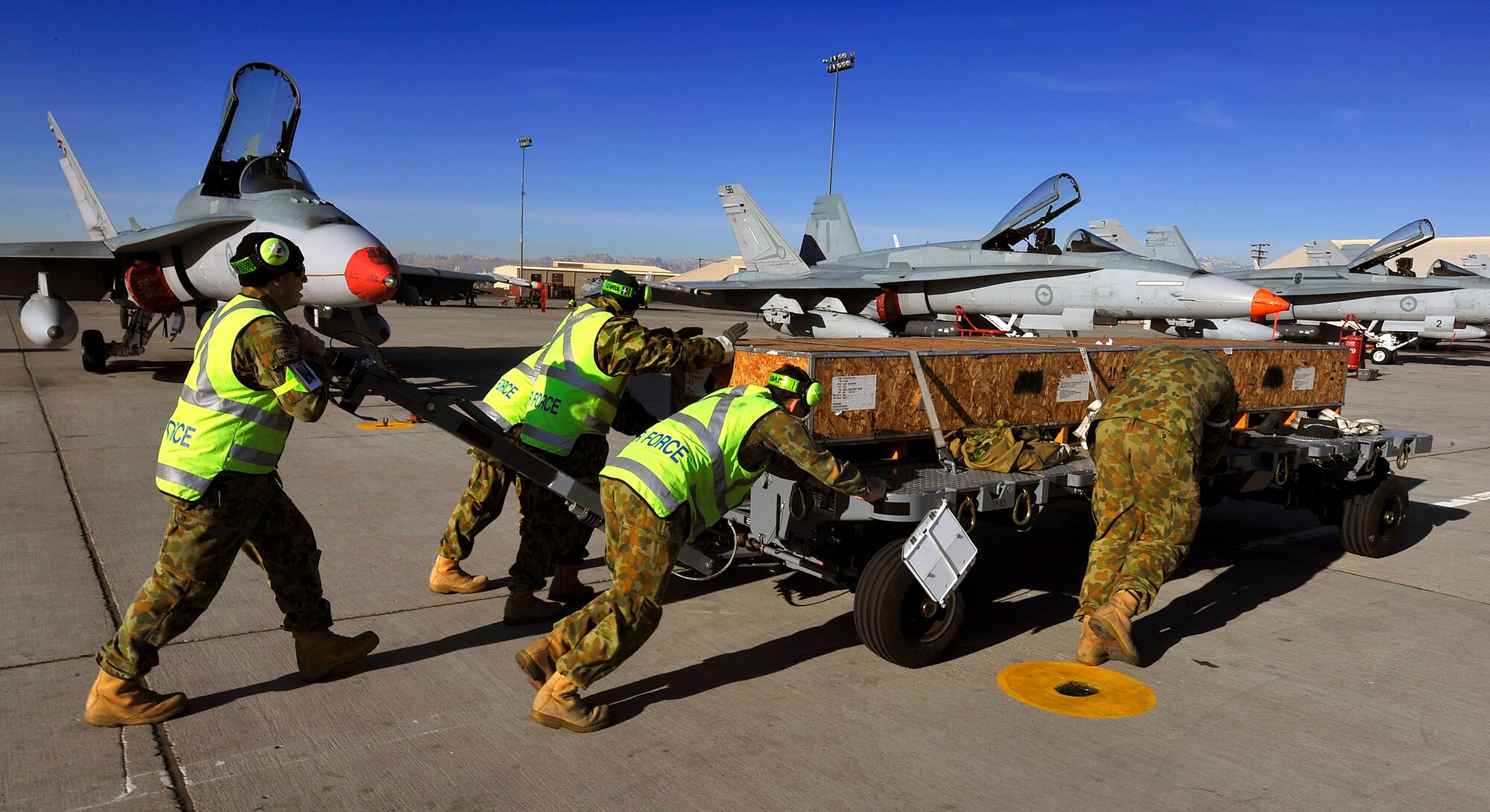 NELLIS AIR FORCE BASE, Nev. -- Members of the 77th Squadron, Royal Australian Air Force, move laser-guided training munitions to be loaded onto F/A-18 Hornets during Red Flag 10-3 Feb. 23. The 77th Squadron is deployed from RAAF Base Williamtown near Newcastle, Australia. (U.S. Air Force photo by Tech. Sgt. Chris Flahive)
